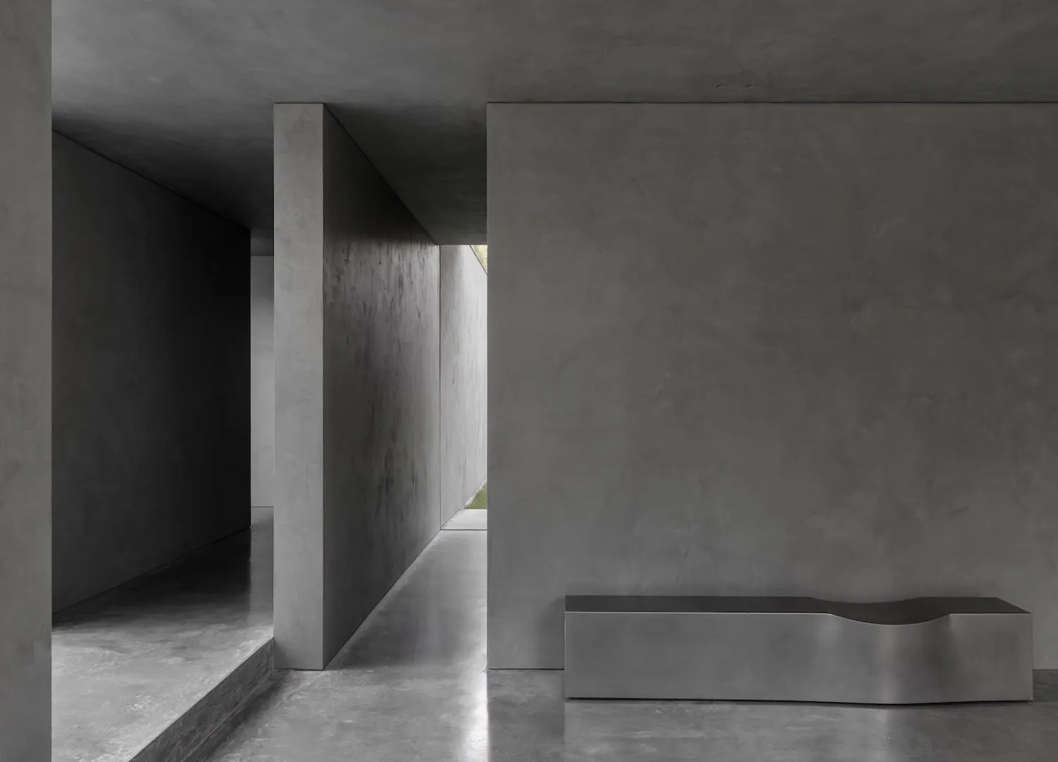 Concrete walls and floor of a modern industrial interior space.