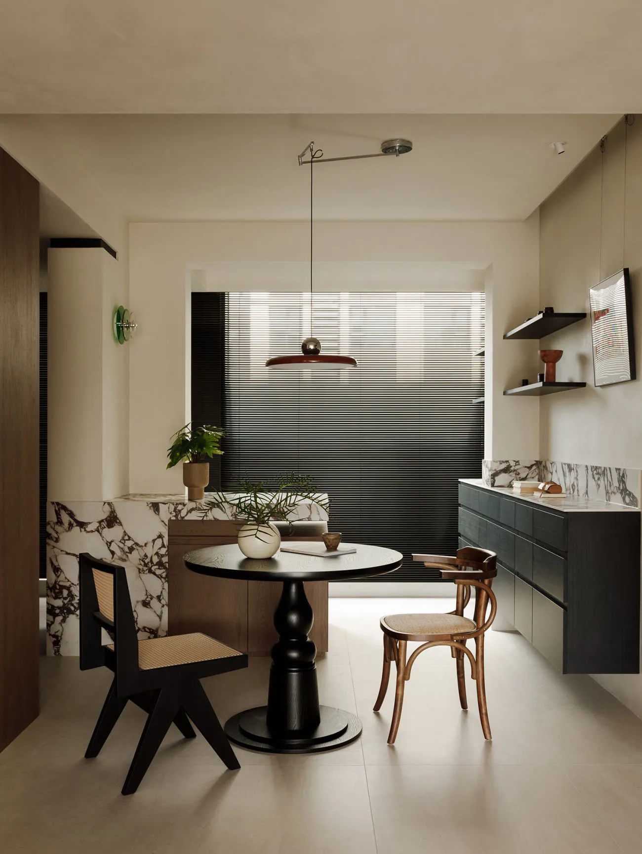 Modern residential kitchen with marble countertops and wooden furniture.