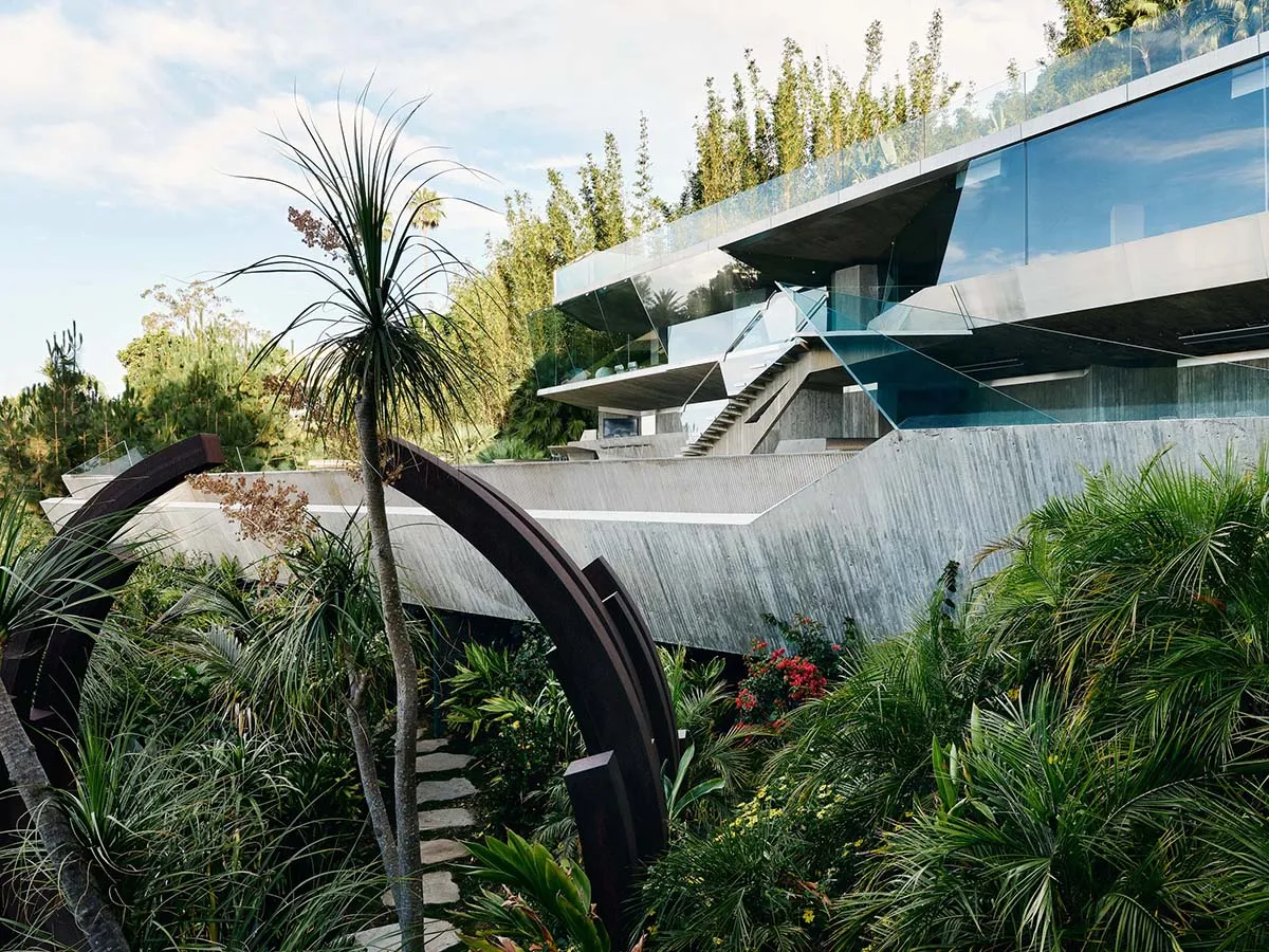 A modern residential house with concrete and glass exterior.