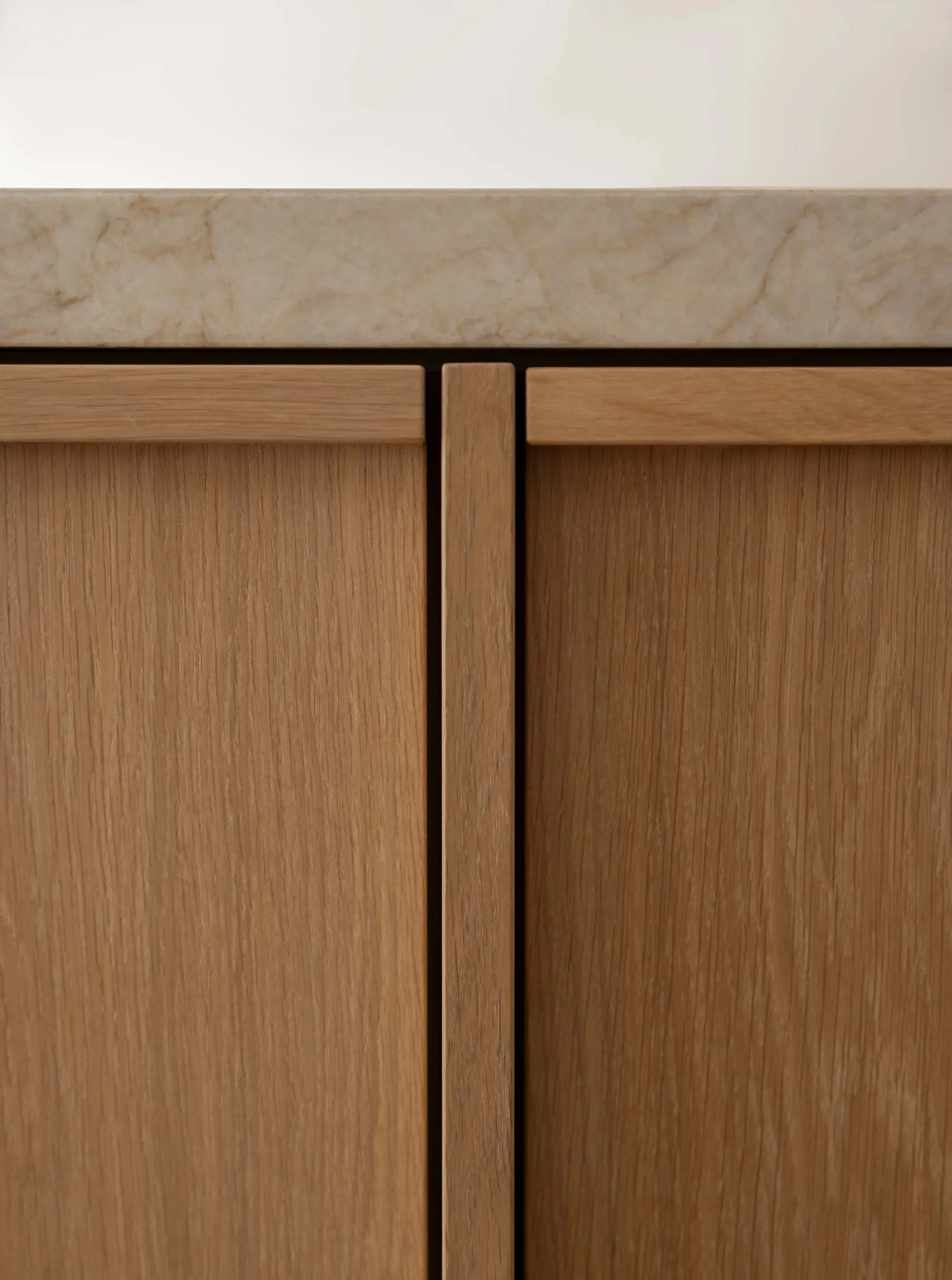 Close-up of a modern minimalist cabinet made of oak wood.