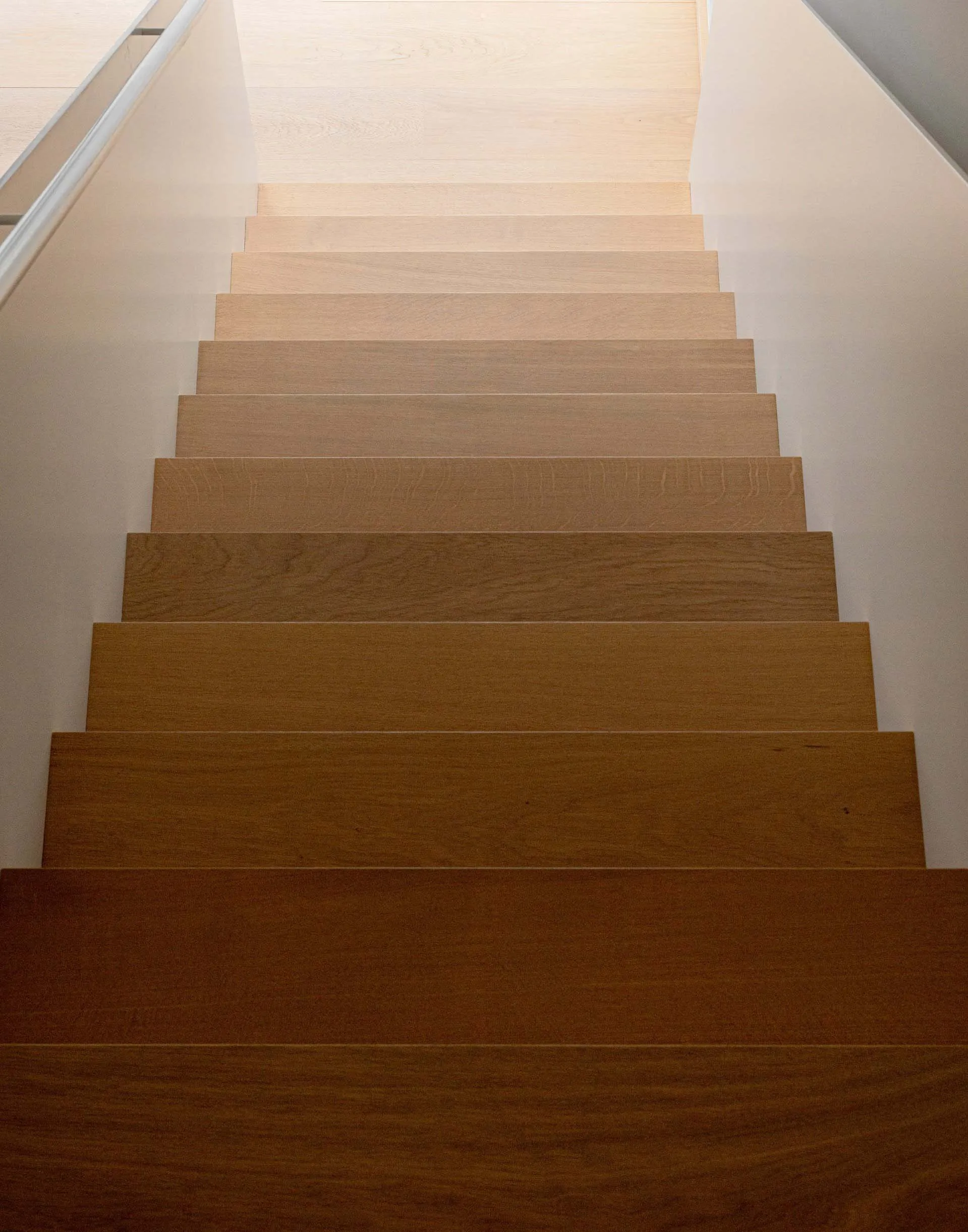 Modern minimalist wooden staircase with gradient shading