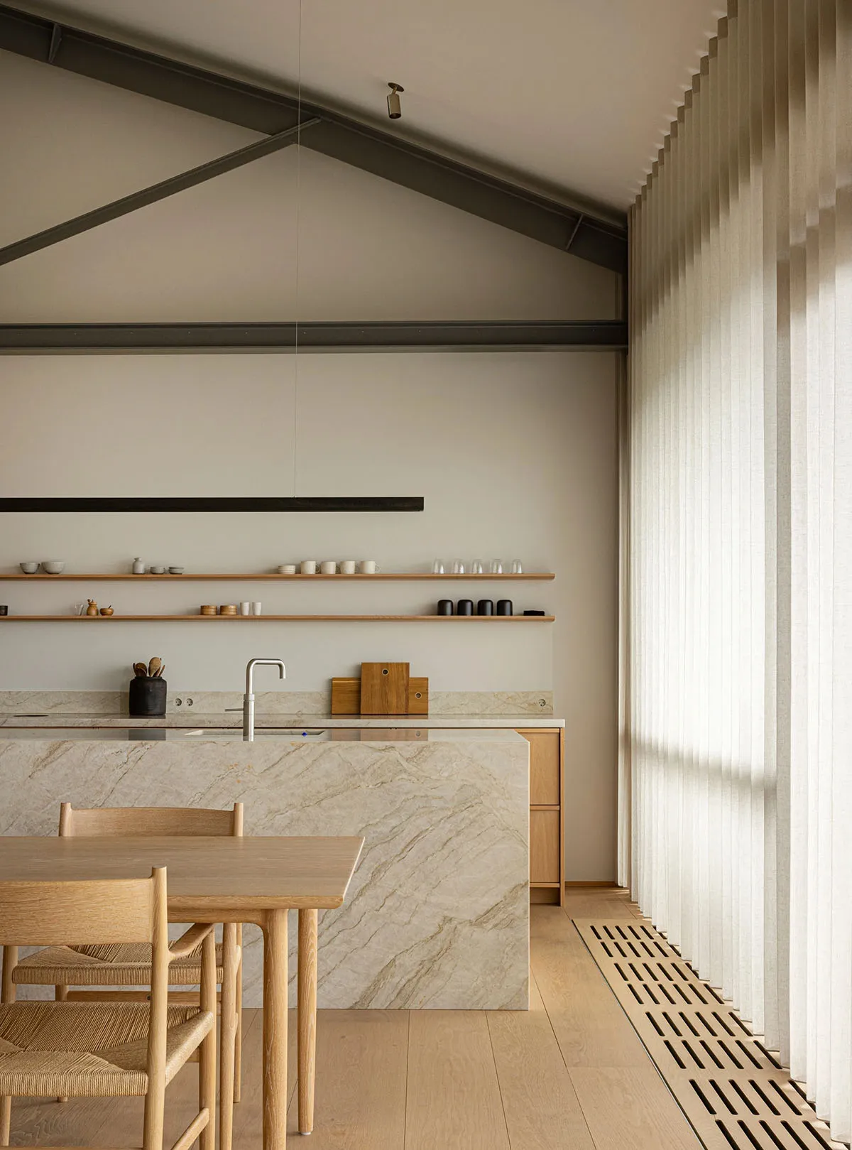 A minimalist kitchen featuring marble countertops and a modern design.