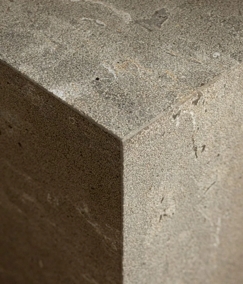 A modern interior design featuring concrete surfaces and minimalist aesthetics.