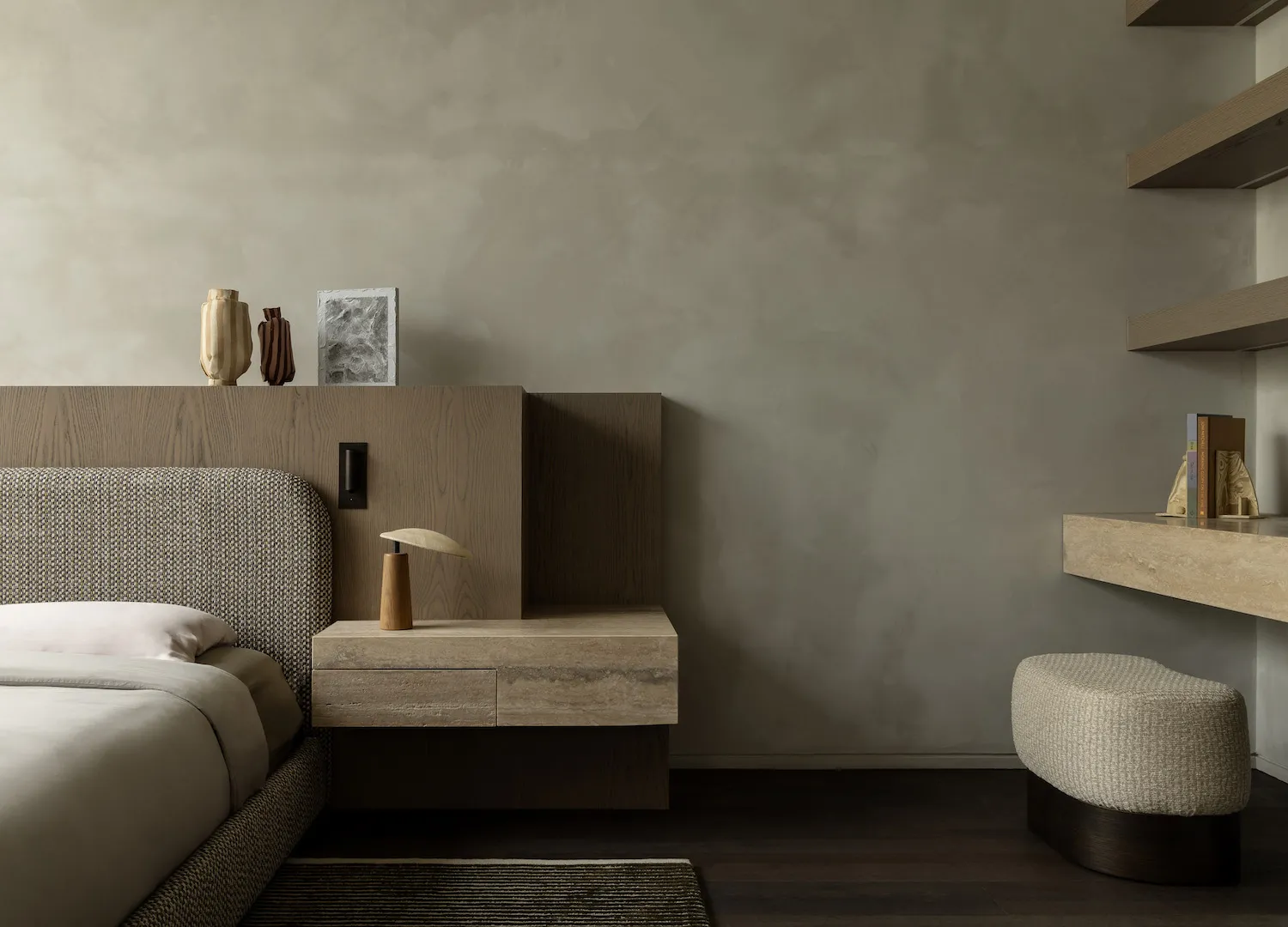 A minimalist bedroom with a wooden headboard, a bed with white bedding, a floating nightstand with a wooden lamp, and a woode