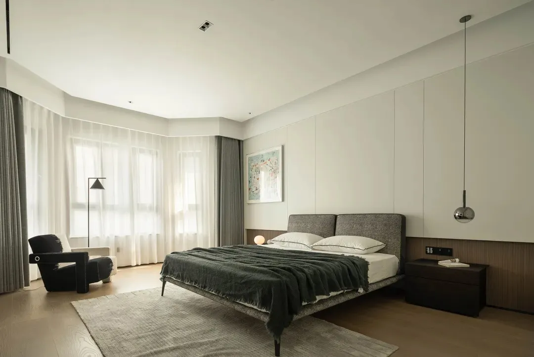 A modern, minimalist bedroom featuring wood, fabric, metal, and glass materials in a clean, open layout.