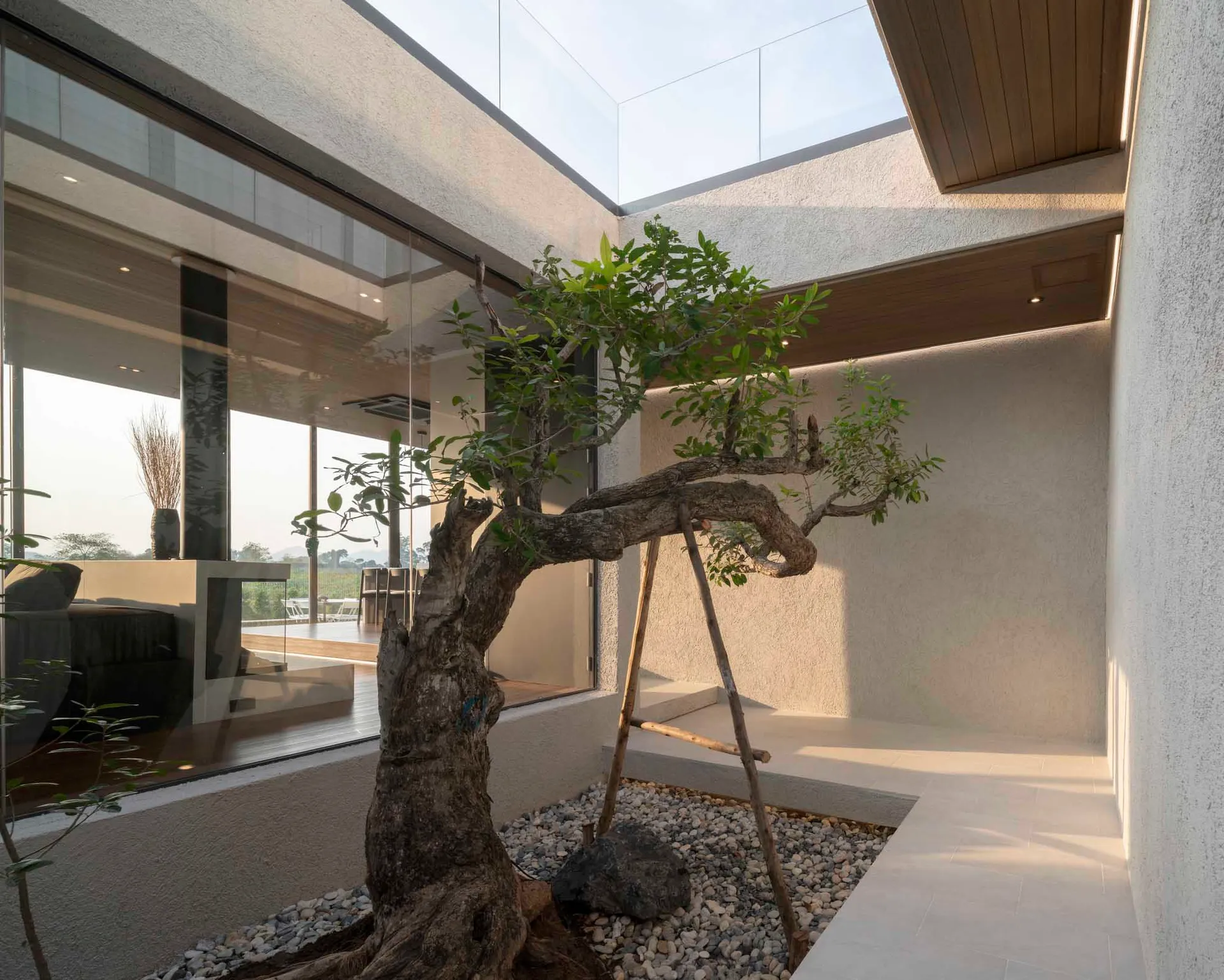 Modern, minimalist interior space with concrete and glass elements.