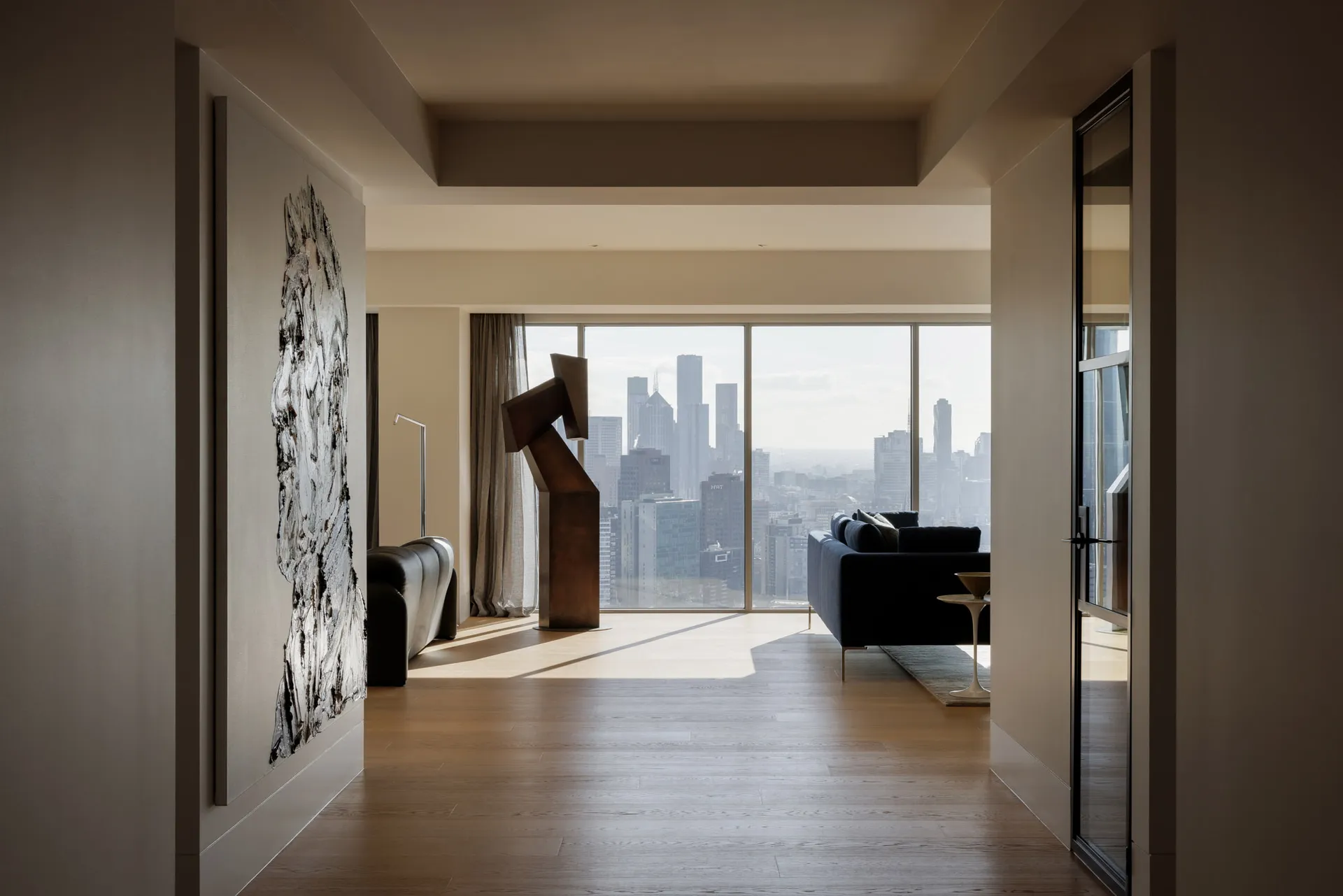 A modern residential apartment featuring concrete walls and glass windows.