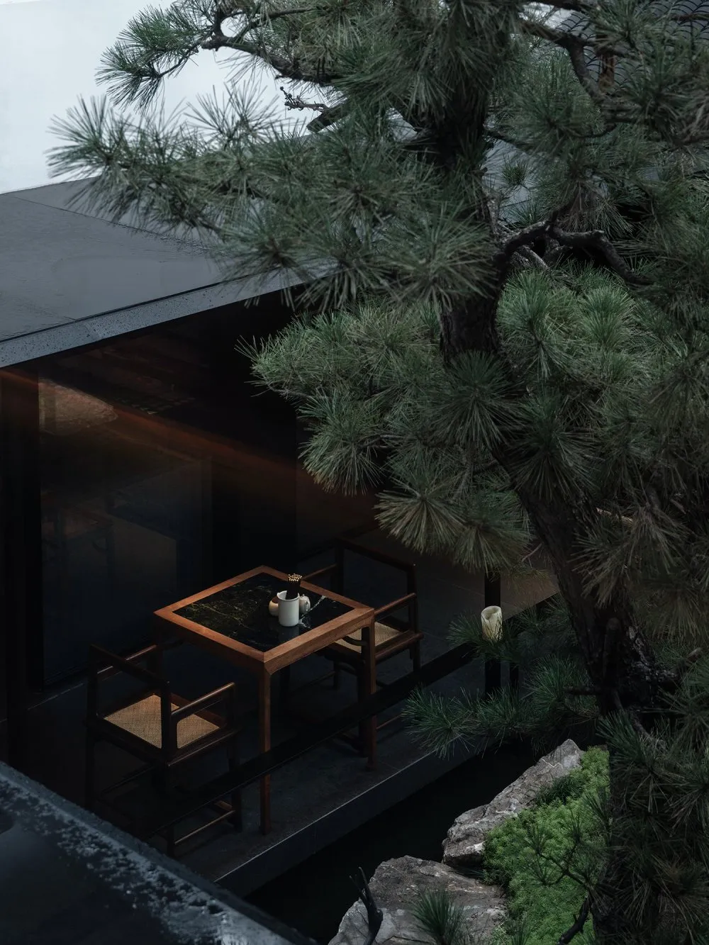 A modern coffee shop interior with a wooden table and chairs, black marble table top, and greenery.