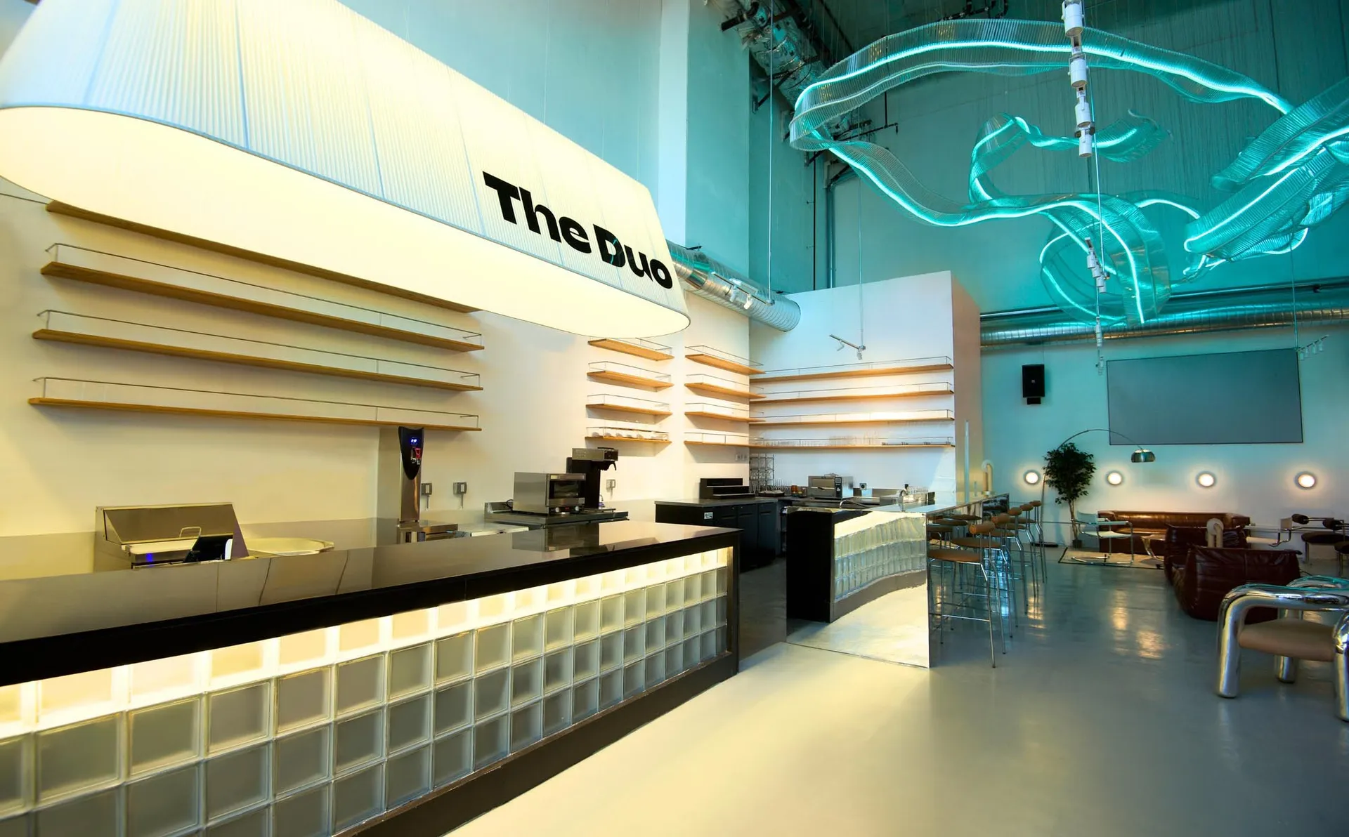 Modern commercial space with glass and concrete walls and lighting fixtures