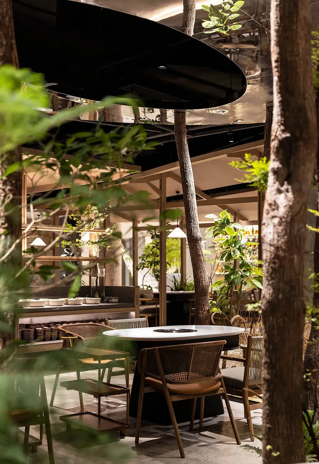 Indoor restaurant interior with industrial design elements such as wood and glass.