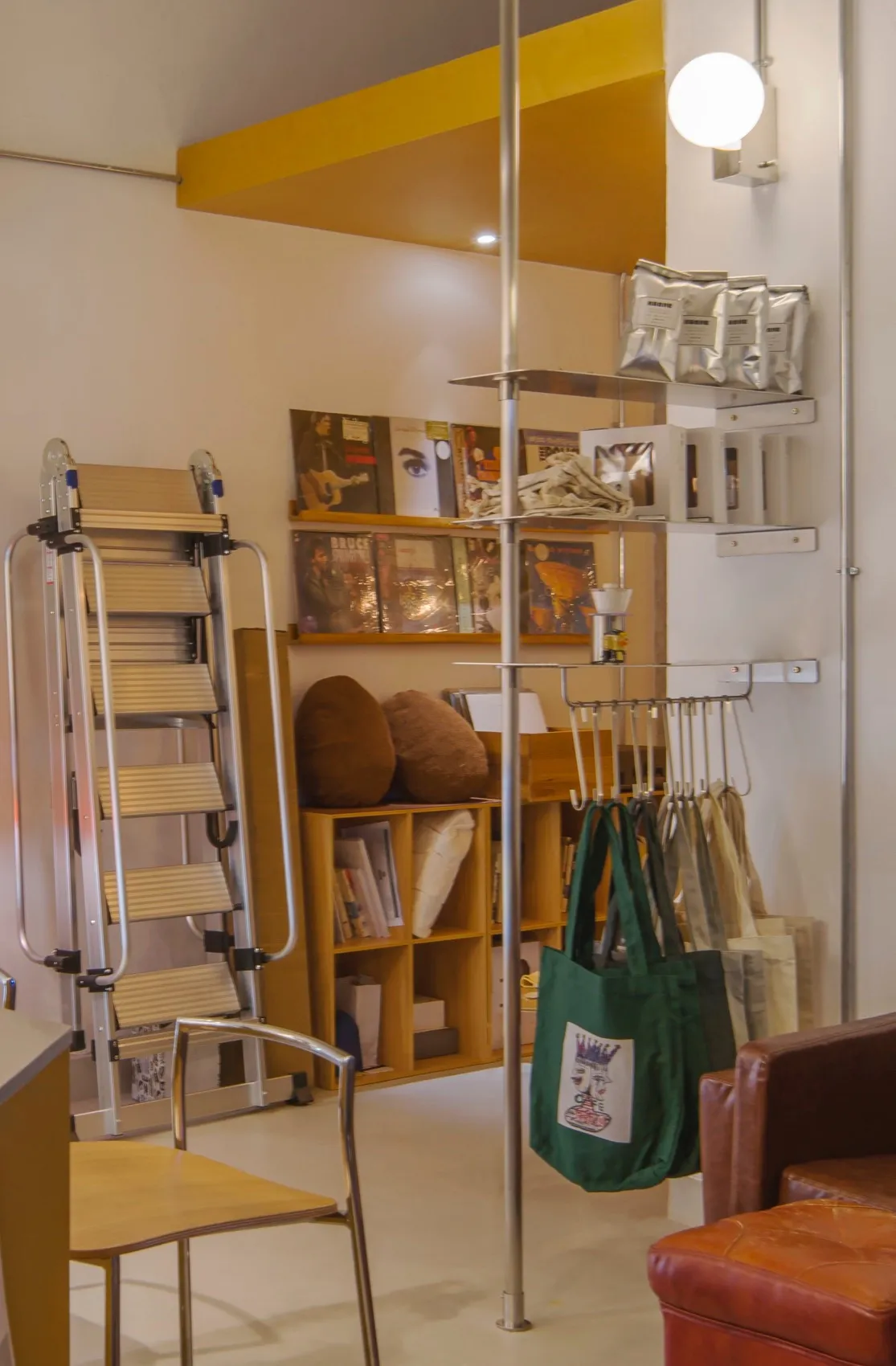 Interior view of a retail store showcasing wooden shelves and bags