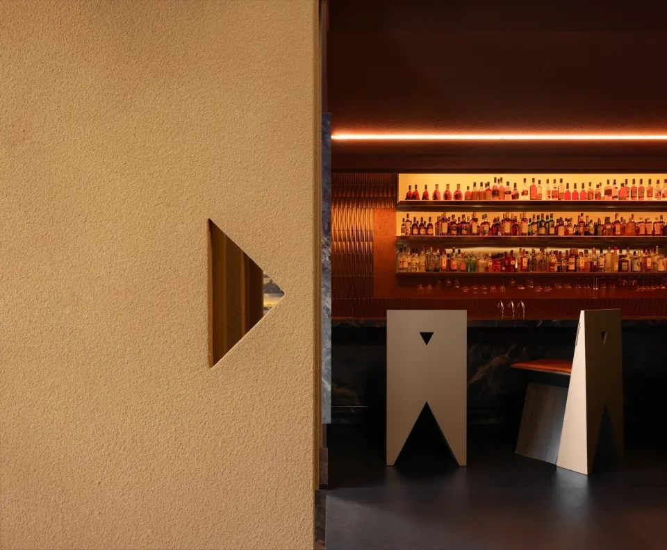 An industrial-style restaurant/bar interior with minimalist design elements.