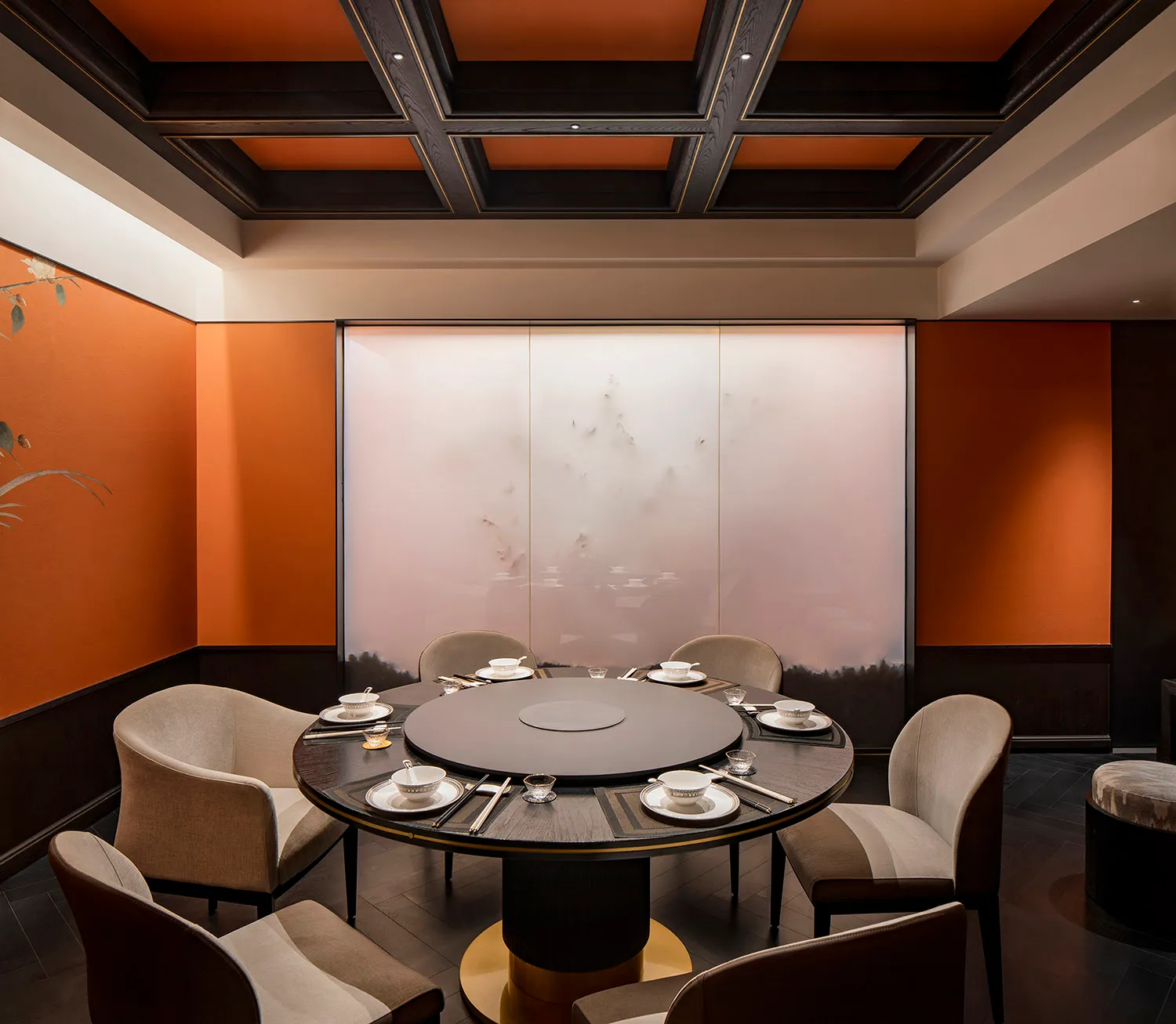 Modern restaurant private dining room with fabric chairs and wooden table.