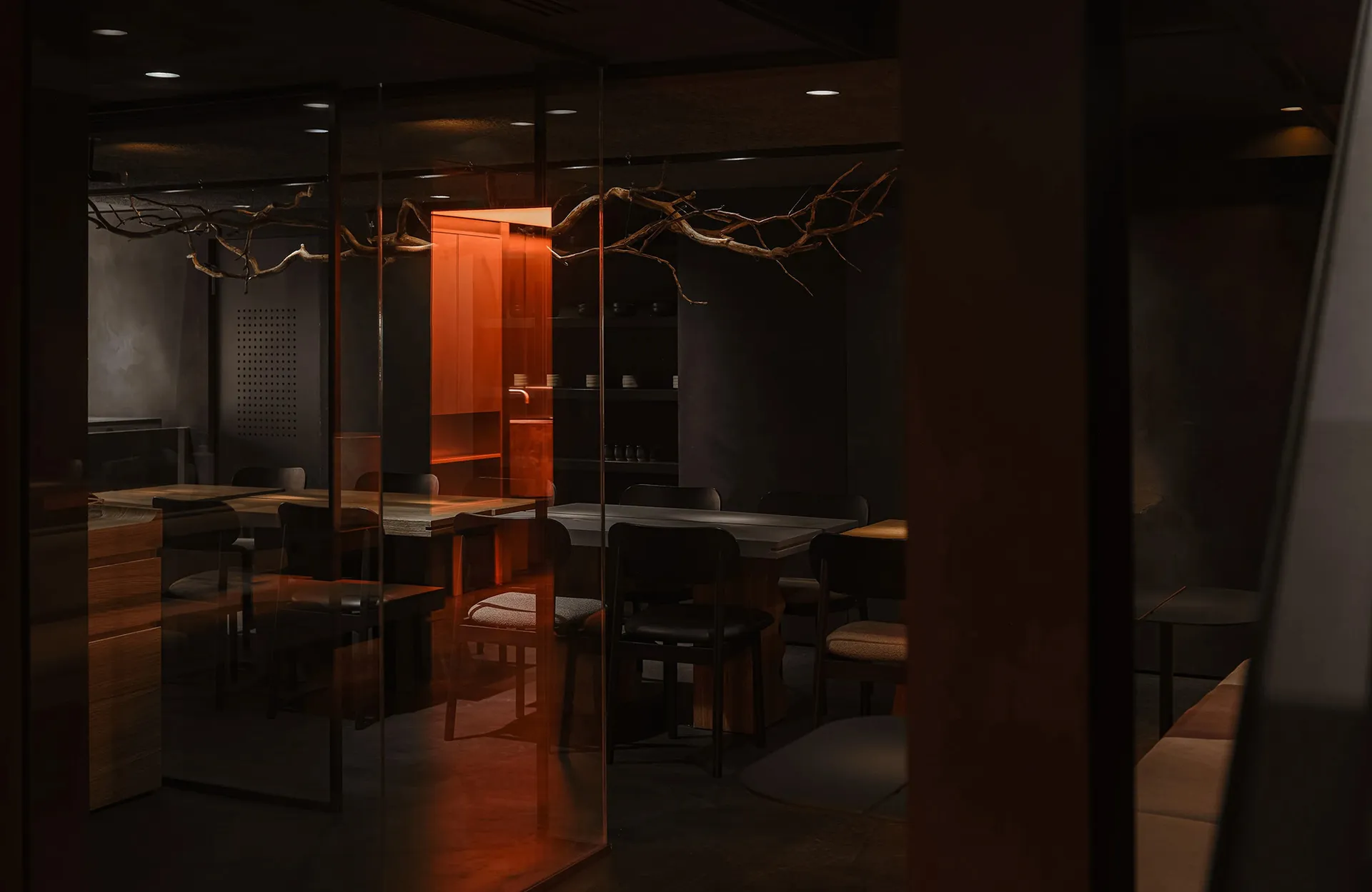 Modern restaurant interior with wooden tables, concrete flooring, and minimalist design.