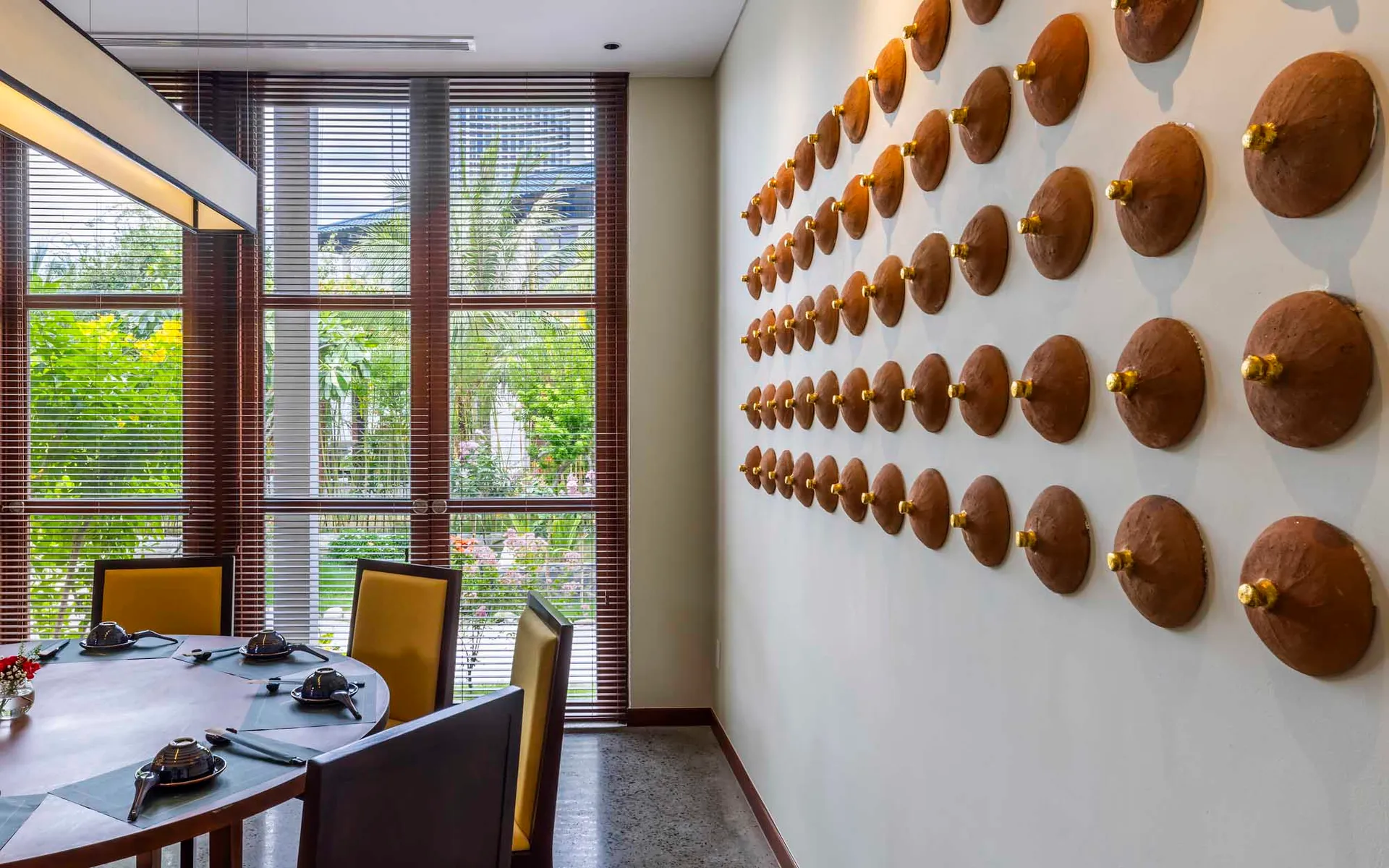 Modern dining room featuring wooden furniture and decorative wall art.