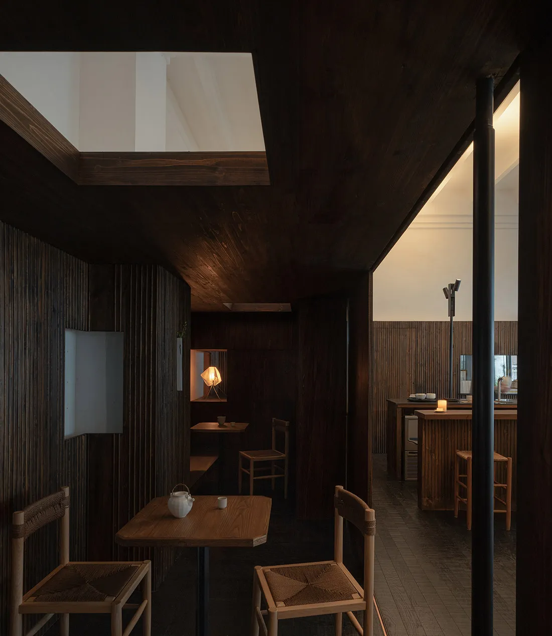 Industrial-style restaurant interior with wooden structures and tables