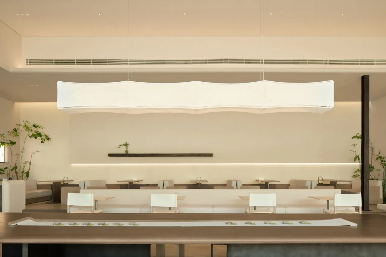 A minimalist modern restaurant interior designed with contemporary furniture and clean lines.