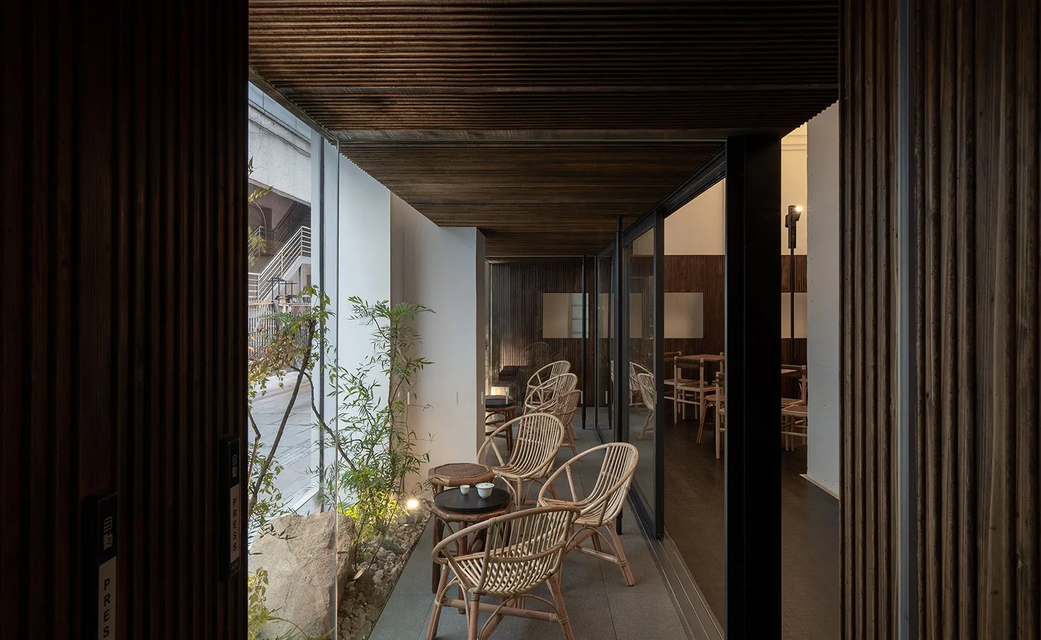 Contemporary coffee shop with wooden walls and cotton furniture.