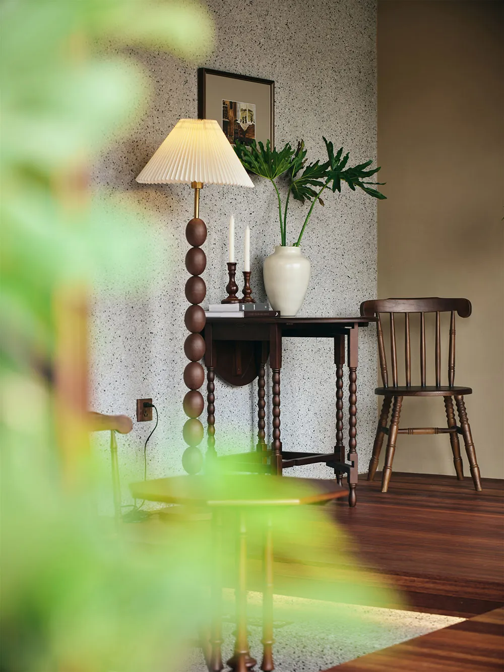 A modern living room featuring a marble coffee table and wooden furniture.