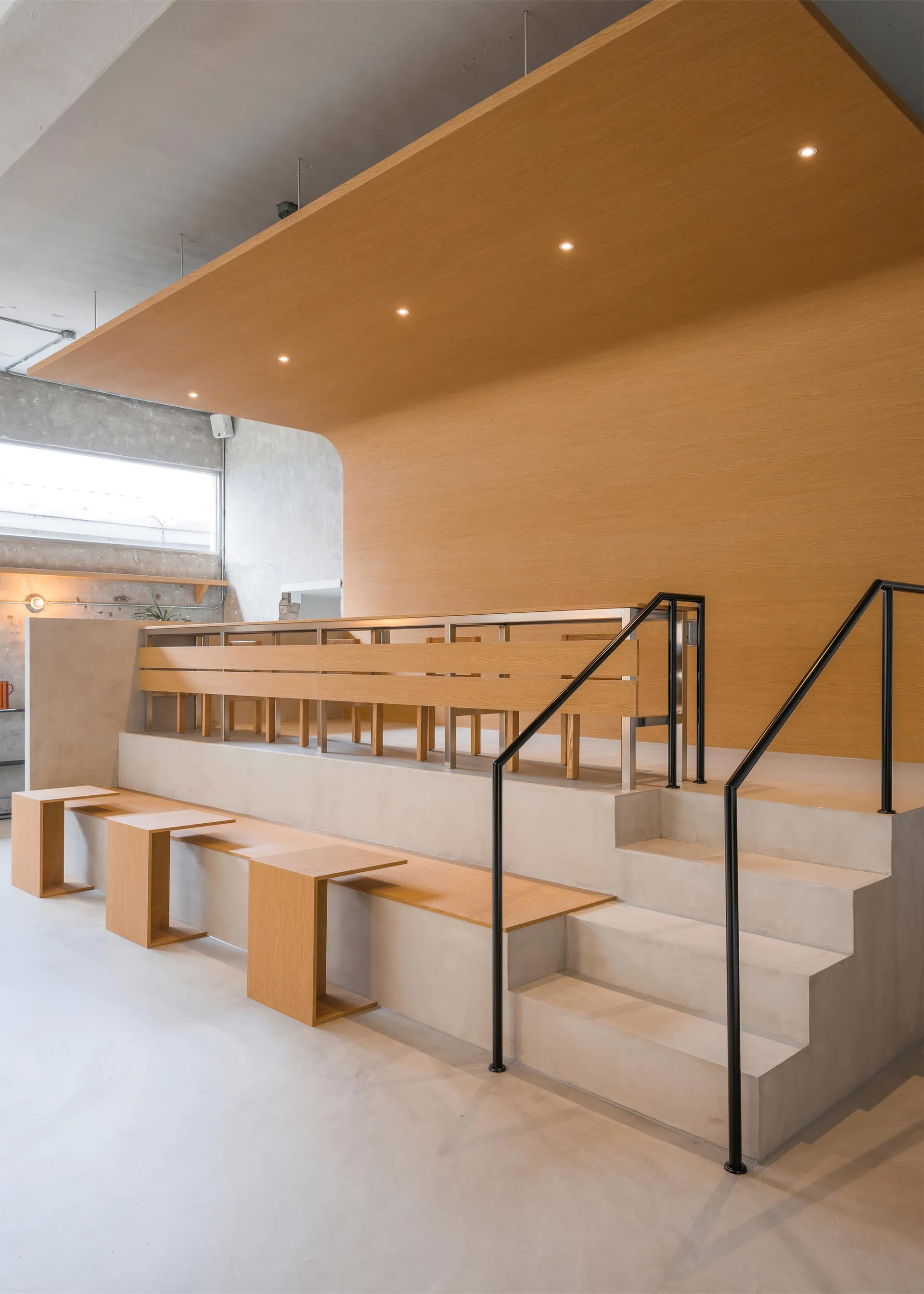 A minimalist interior design featuring concrete and wood materials.