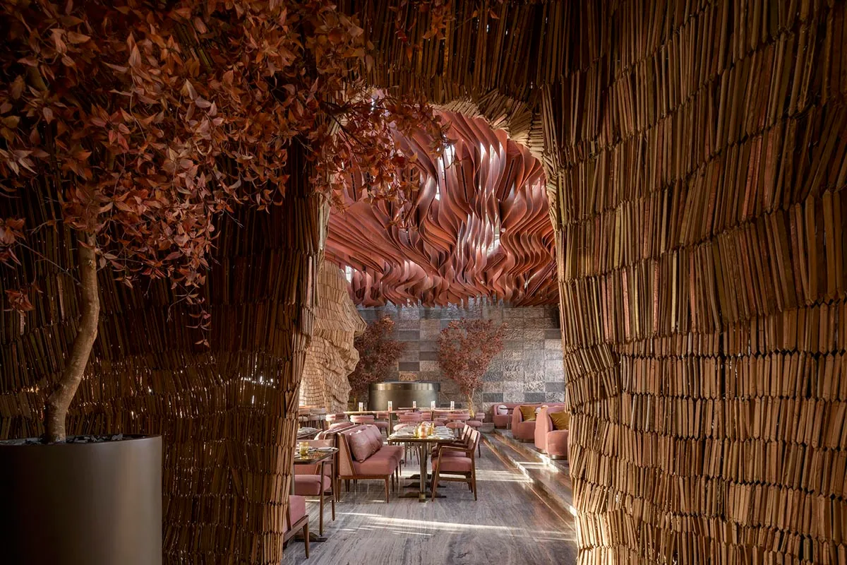 Modern restaurant interior featuring wooden accents, tables, and chairs.