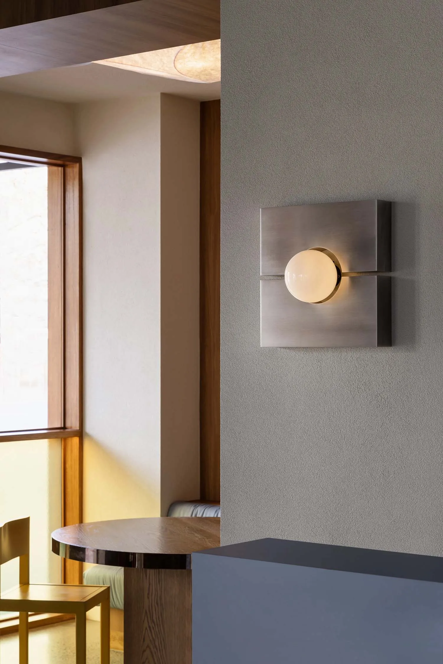 A modern, industrial living room featuring metallic finishes and minimalist design.