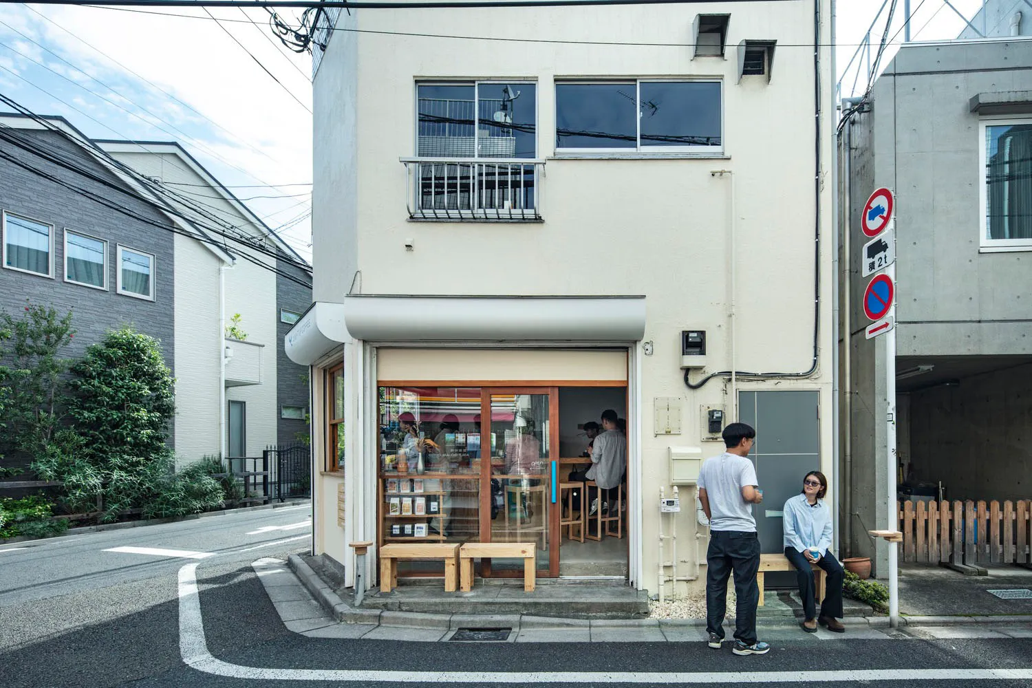 A modern retail storefront with concrete materials on the exterior.