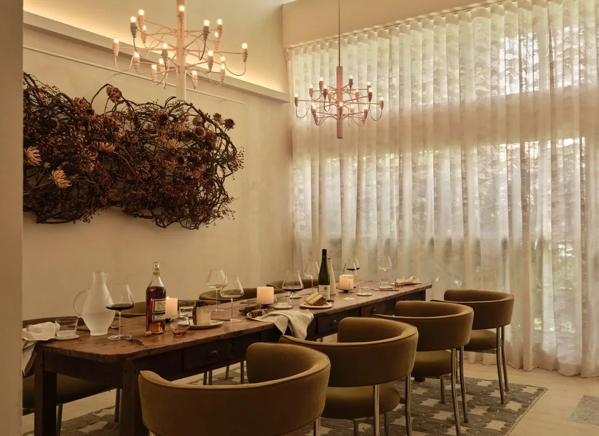 A modern dining room with decorative lighting and elegant furniture.