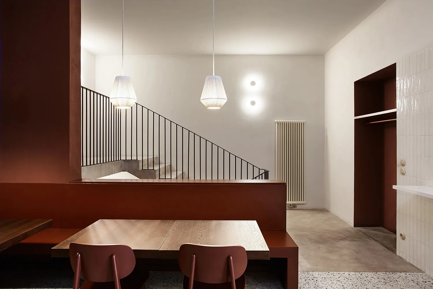 Modern interior design featuring wooden furniture and stairs.
