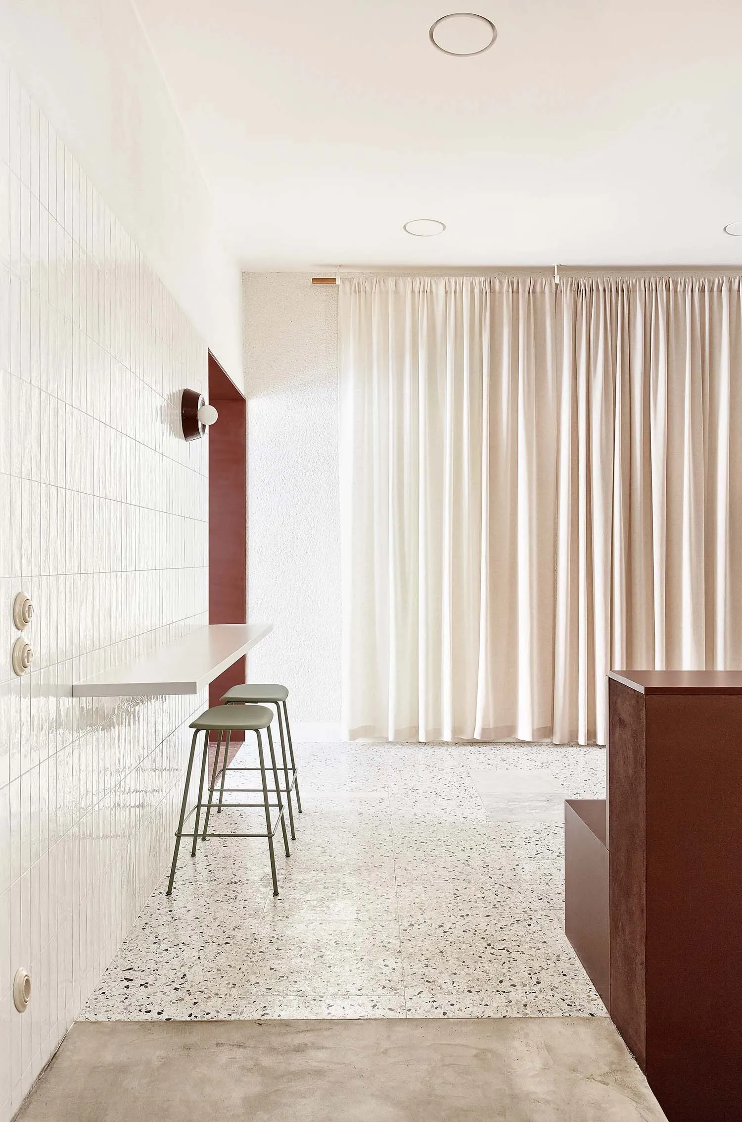 Modern interior space featuring terrazzo flooring and minimalist design elements.