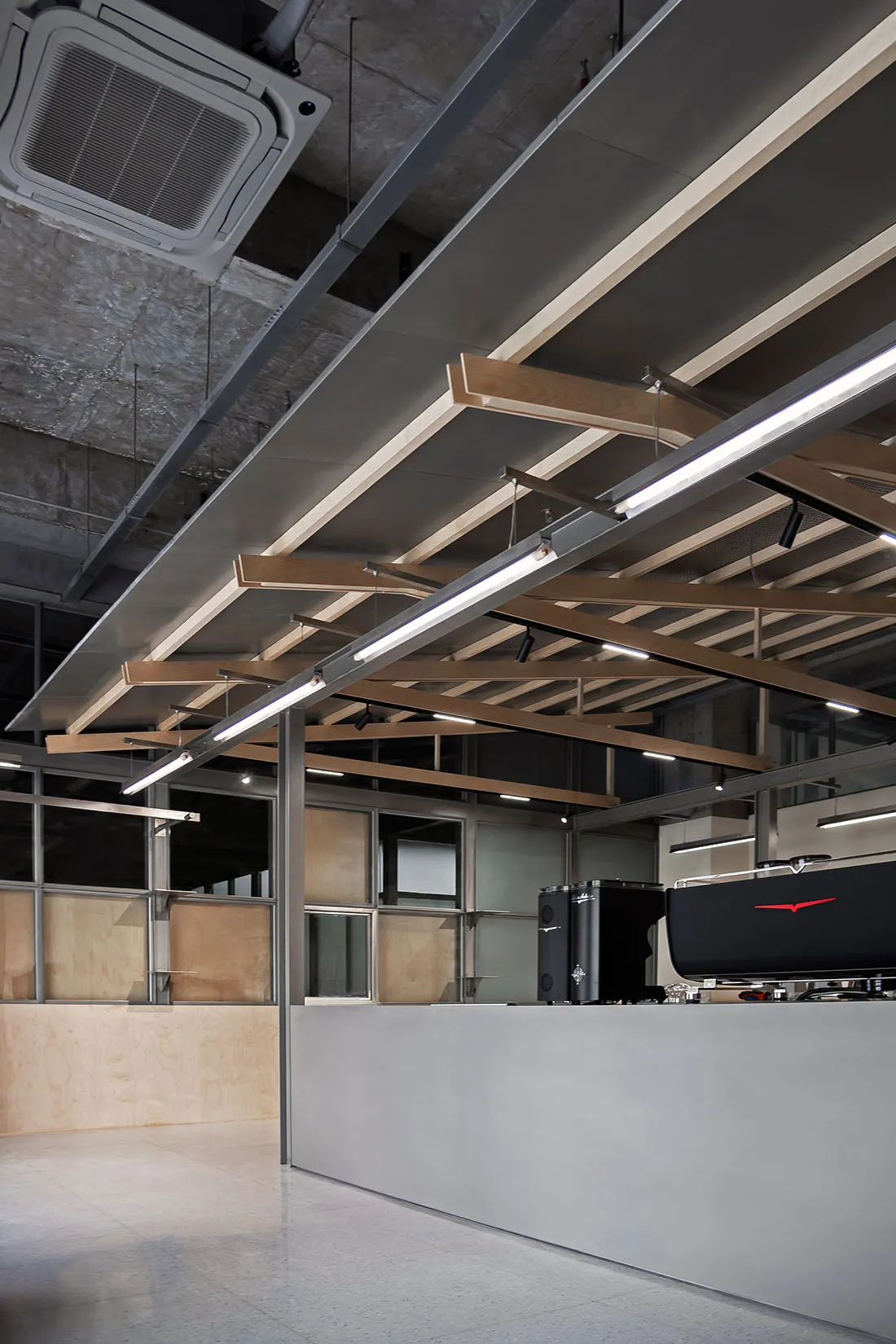 Industrial-style coffee shop counter featuring metal and wood components.