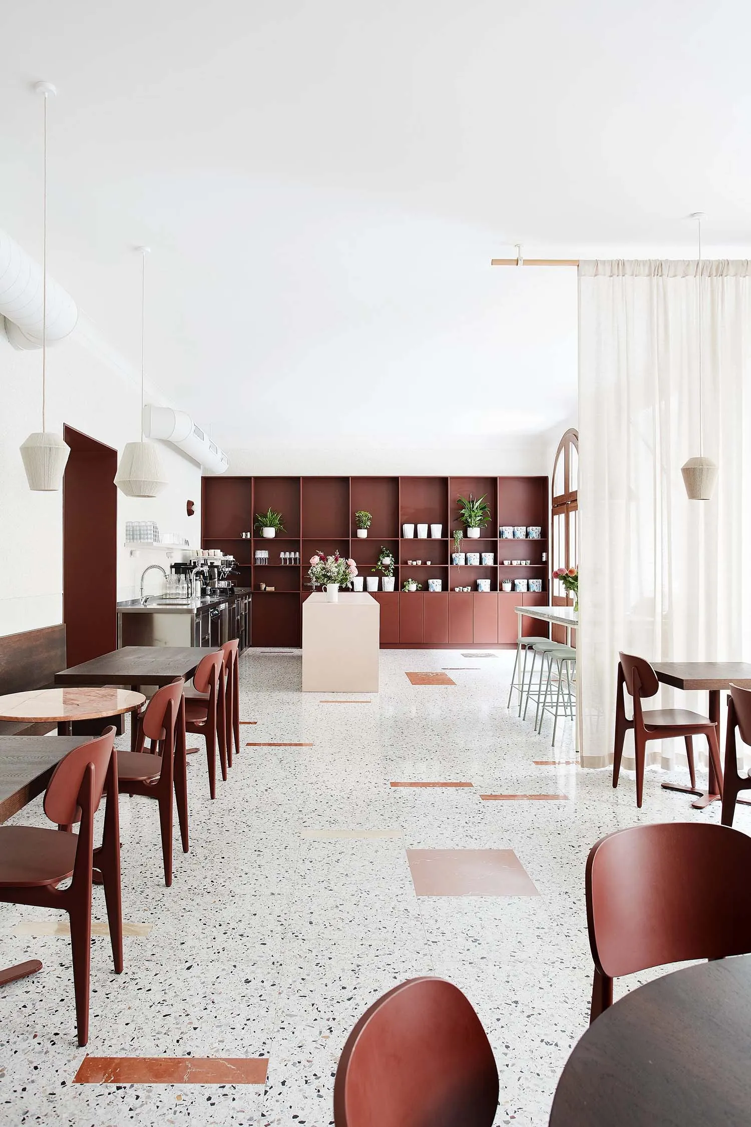 Interior design of a modern coffee shop featuring terrazzo flooring.