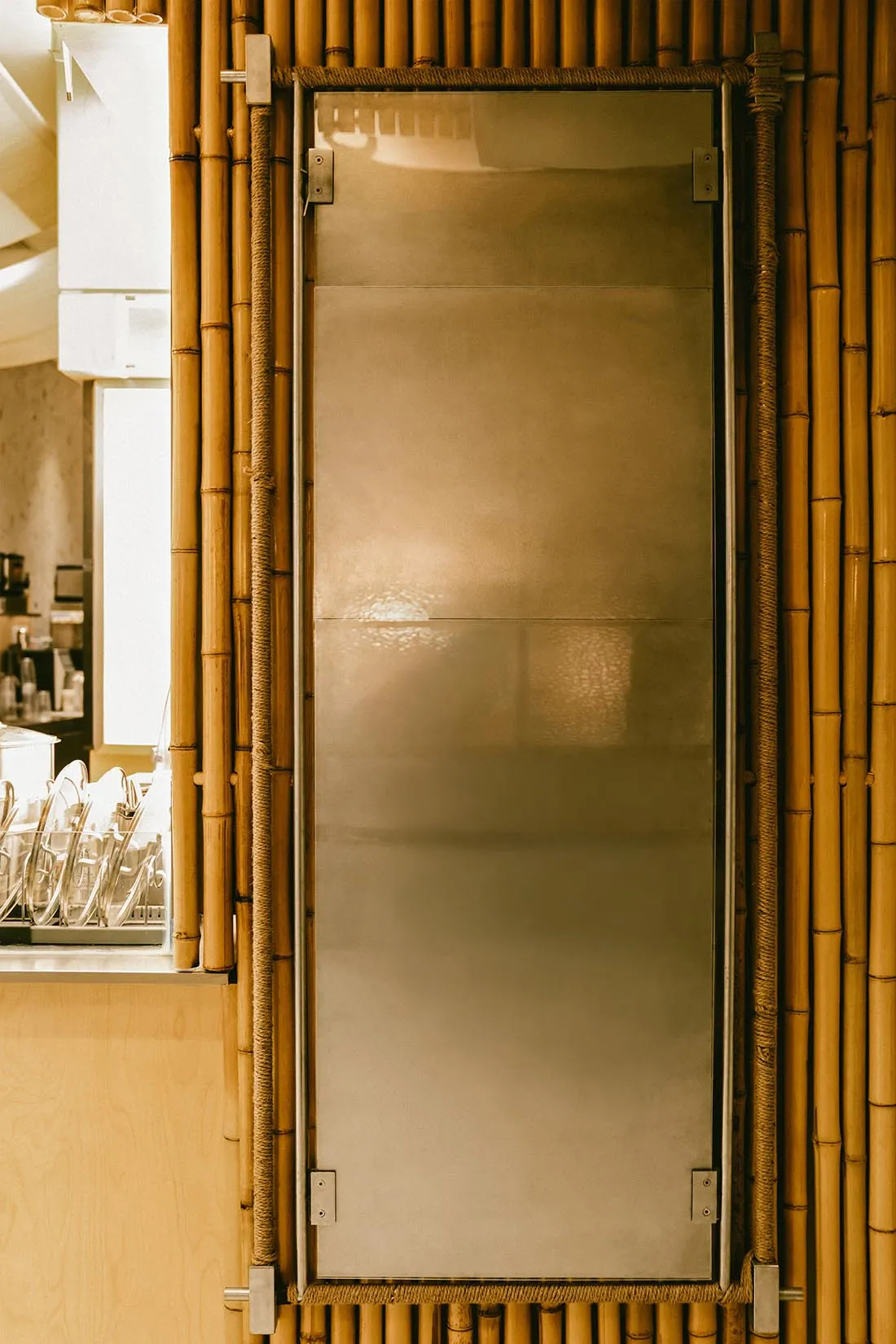 A metal door with a glass panel in a restaurant setting