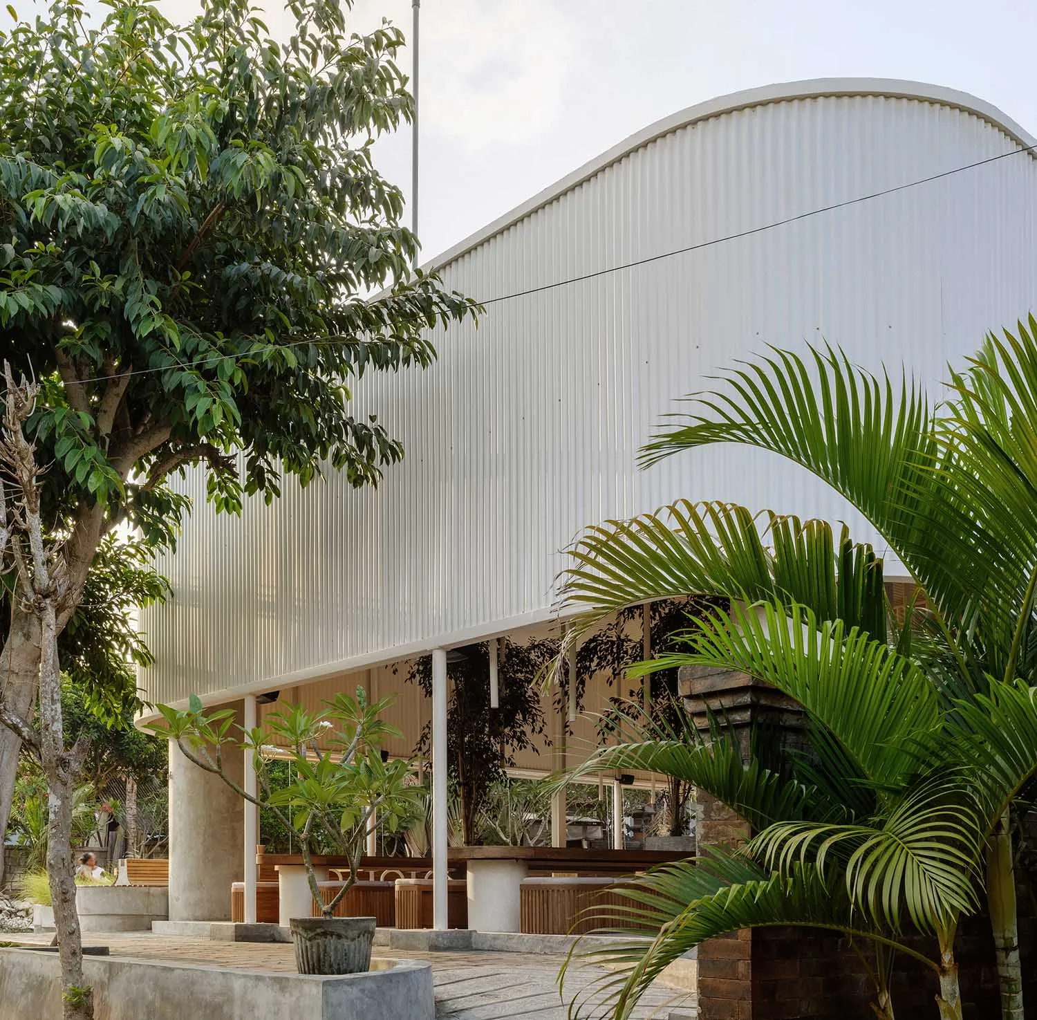 Photograph of a modern building with a curved, corrugated metal exterior.