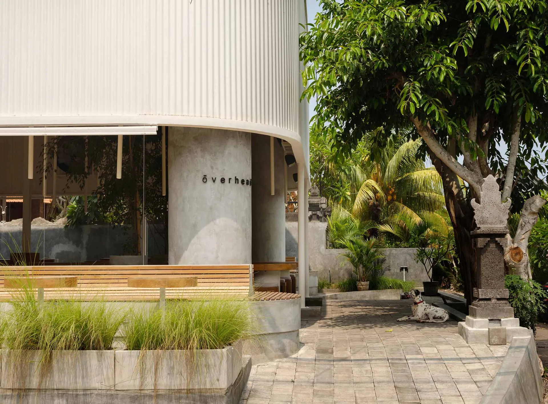 A modern public space with concrete, wood, and glass materials.