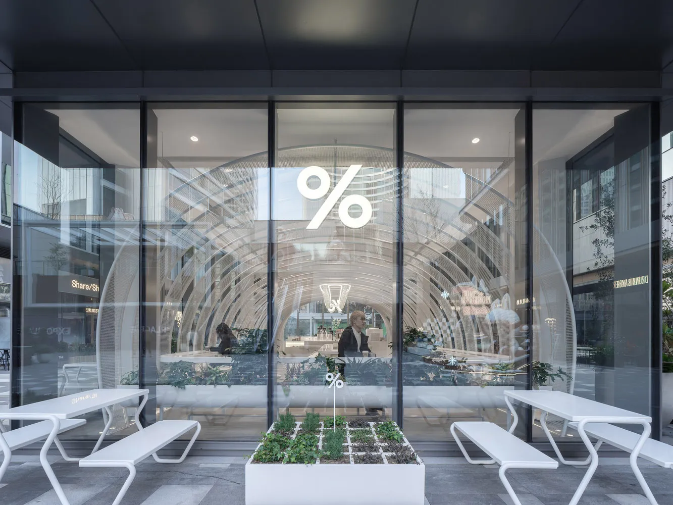 Modern retail entryway featuring glass doors and minimalist interior design.