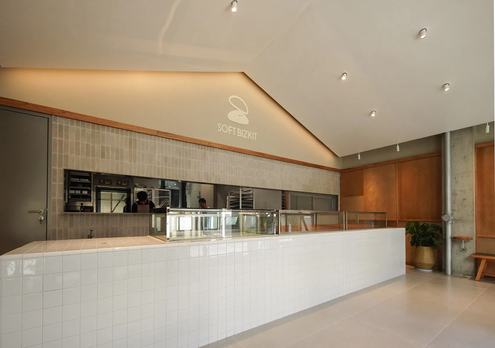 Modern, minimalist cafe counter with tiled surface.