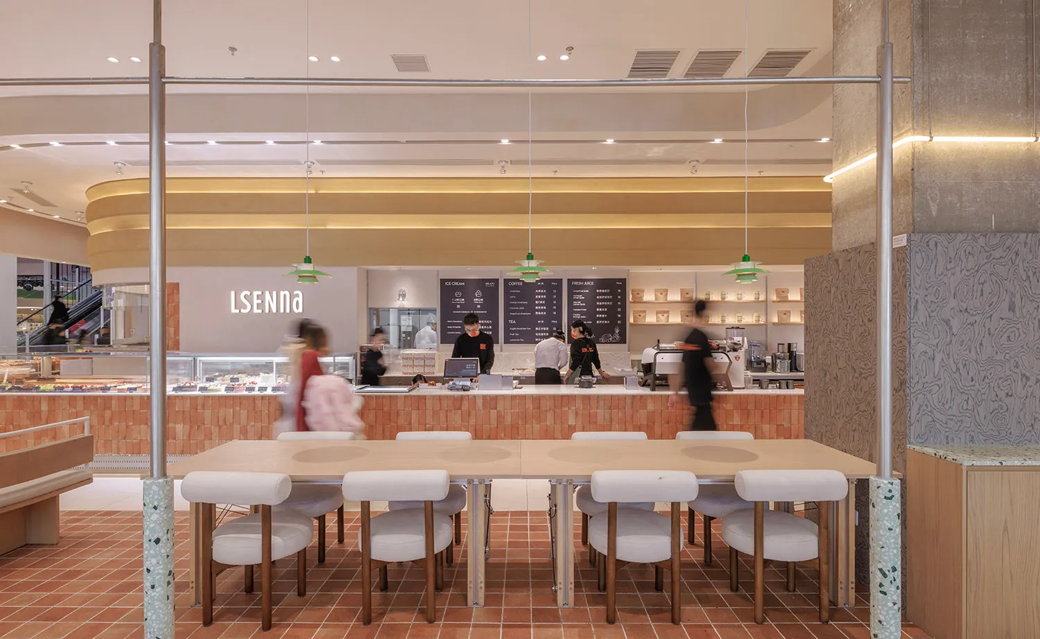 A modern cafe with minimalist design elements featuring a terrazzo floor and white cushions on chairs.