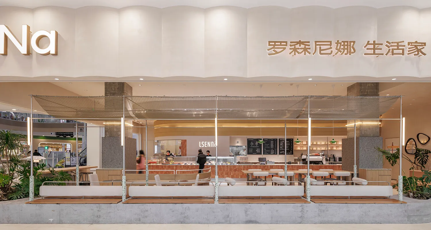 Modern coffee shop with a concrete counter and seating area.