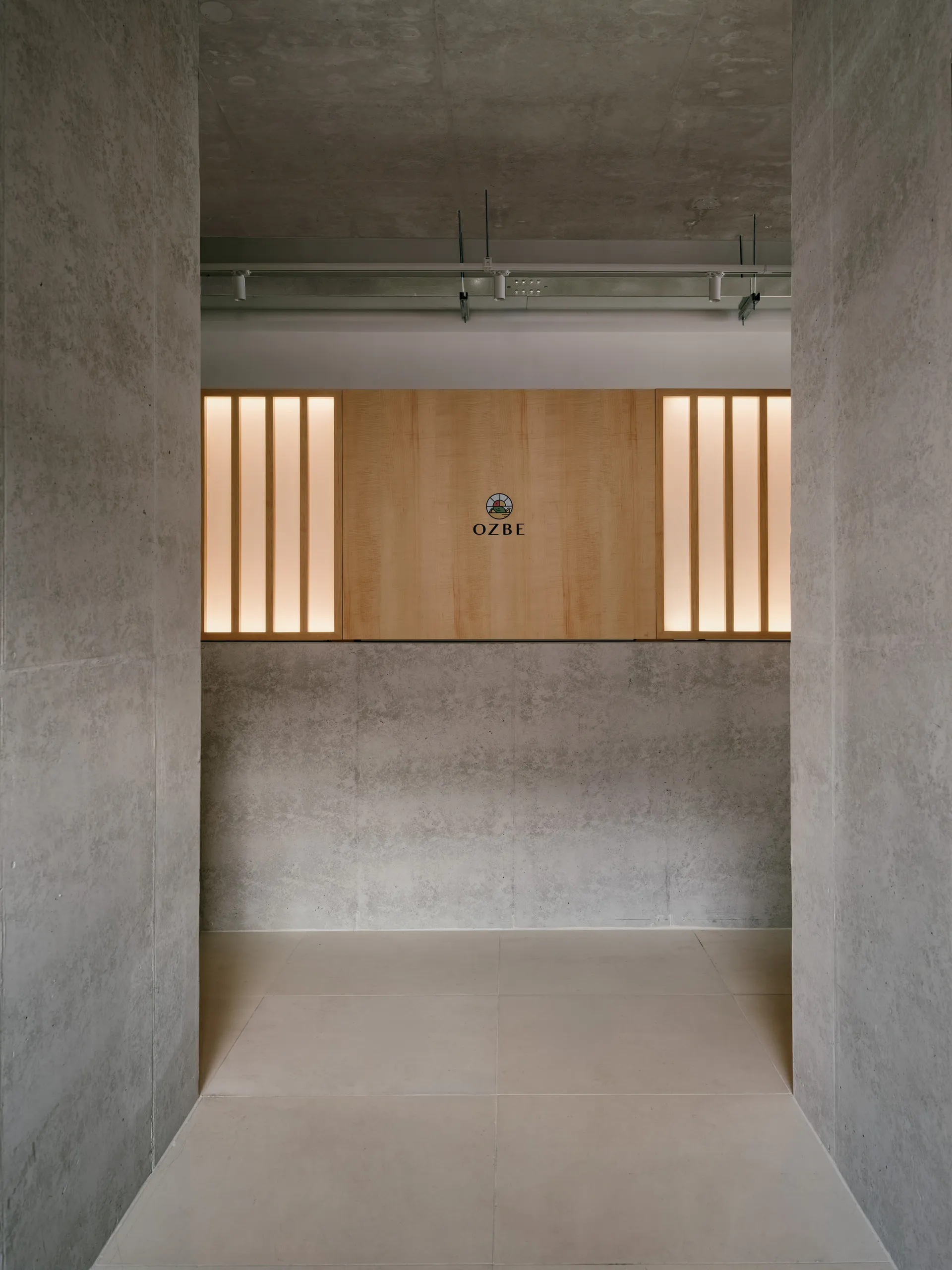 Modern interior space with concrete walls and wooden elements.