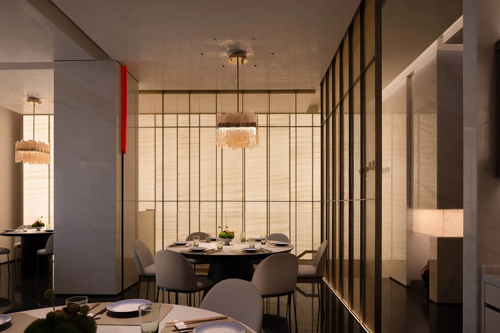 A modern minimalist restaurant interior with fabric curtains, metallic accents, and marble tables and chairs.