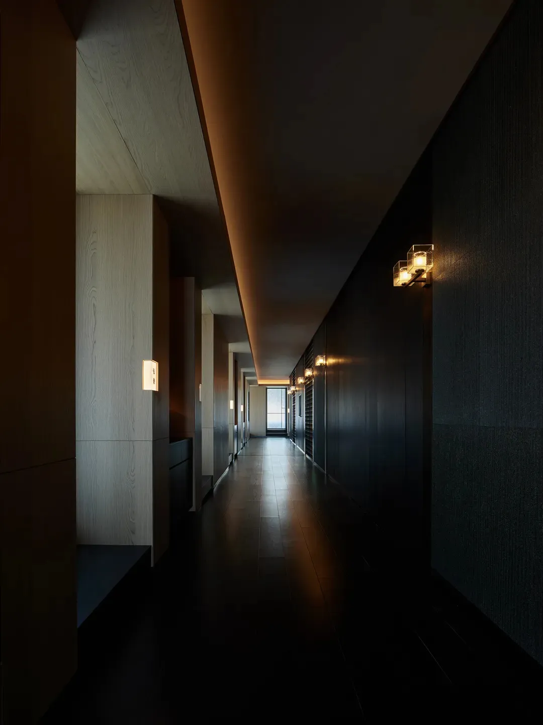 A modern minimalist corridor with floating lights and dark interior walls.
