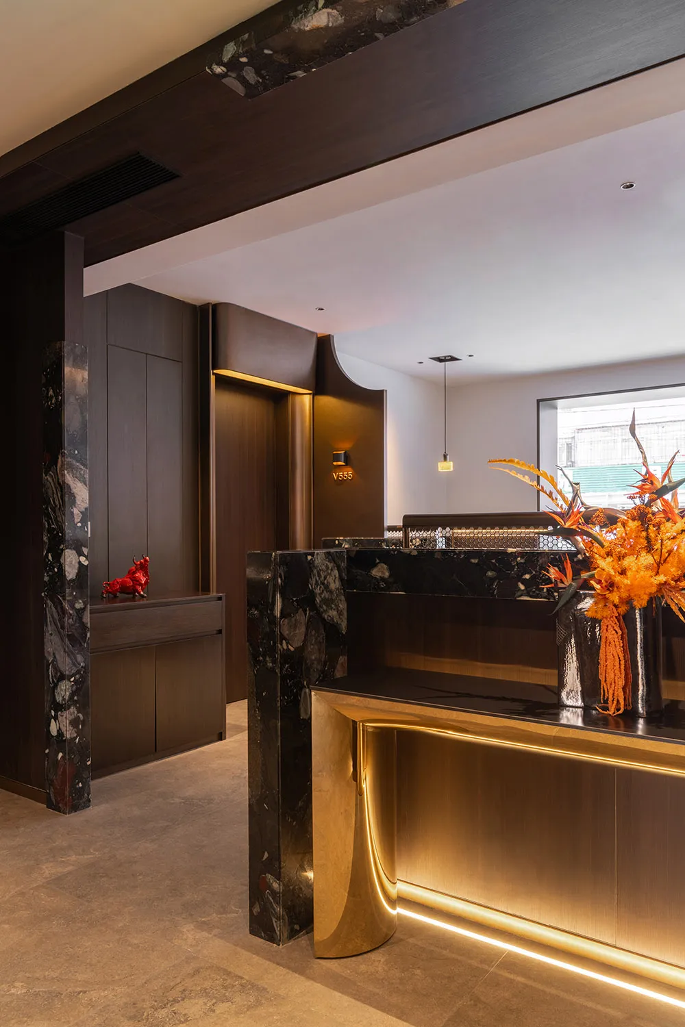 Modern office reception desk featuring marble and metal materials.