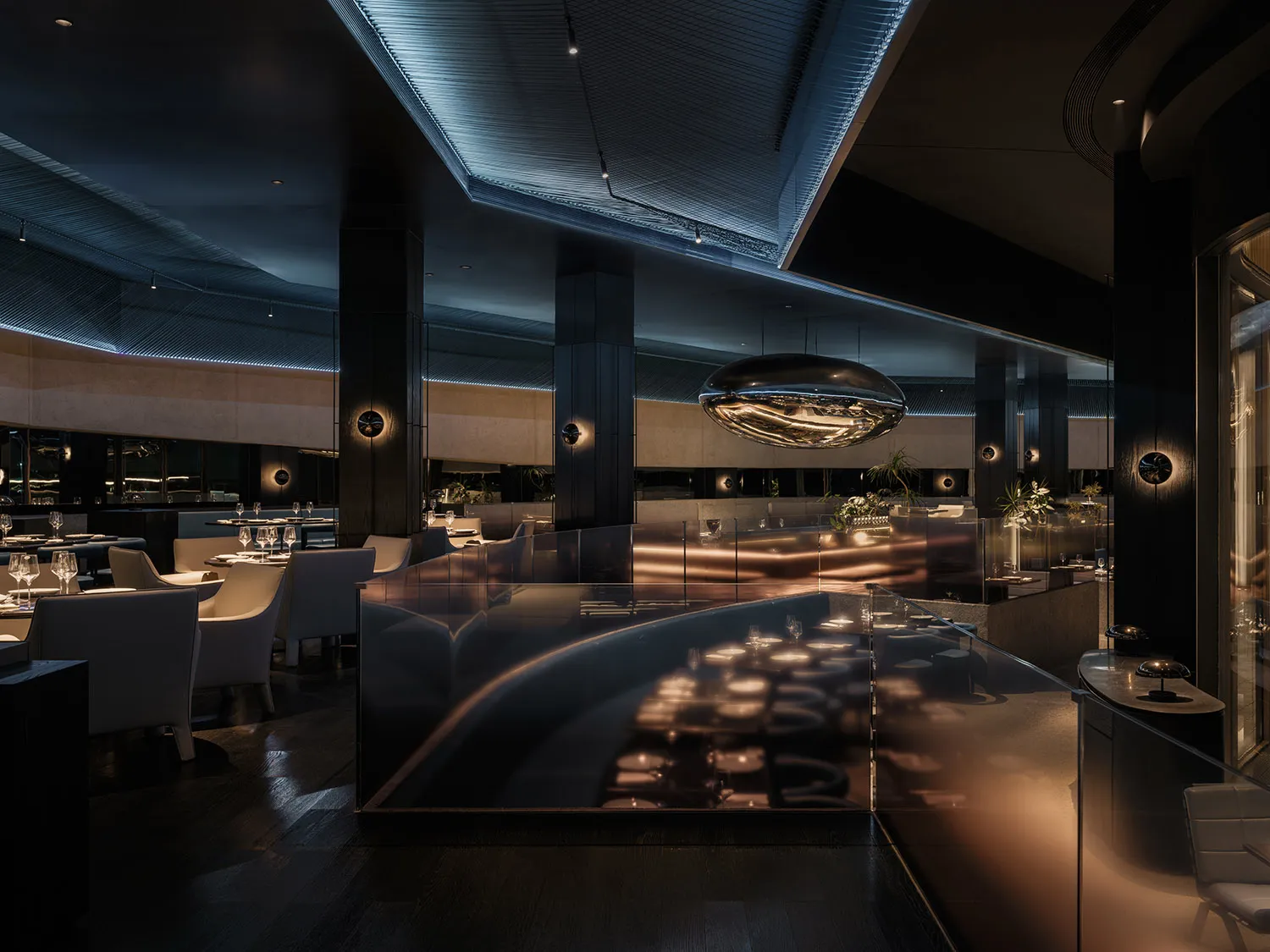 Modern, industrial restaurant interior with metal, glass, and wood.