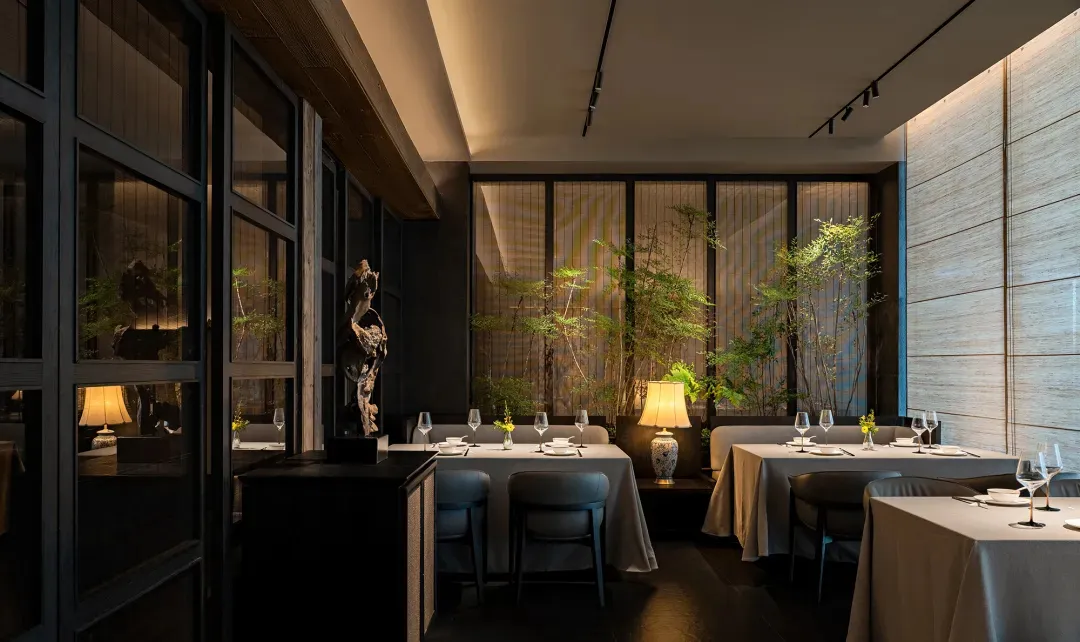A well-lit, contemporary restaurant interior with modern furnishings and decor, featuring sleek tables, chairs, and wall-moun