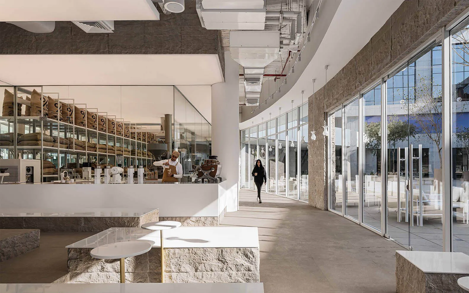 Modern cafe with marble, glass, metal, and concrete interior design.