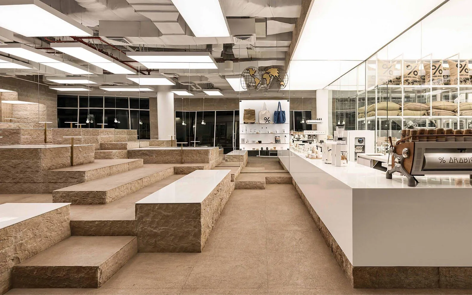 Modern cafe interior with stone elements and a minimalist design.