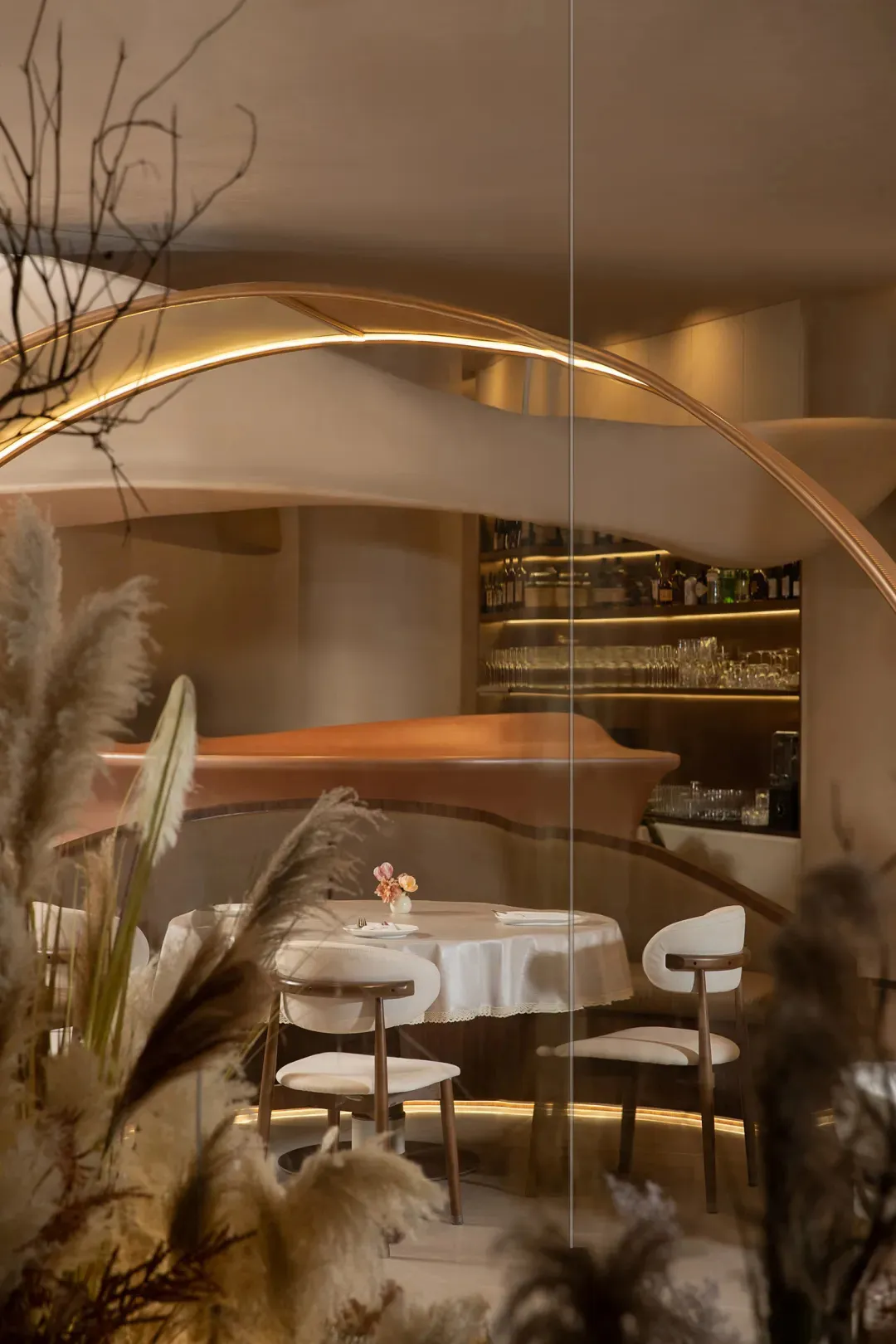 Interior of a modern restaurant with casual dining setup featuring soft textiles and leather