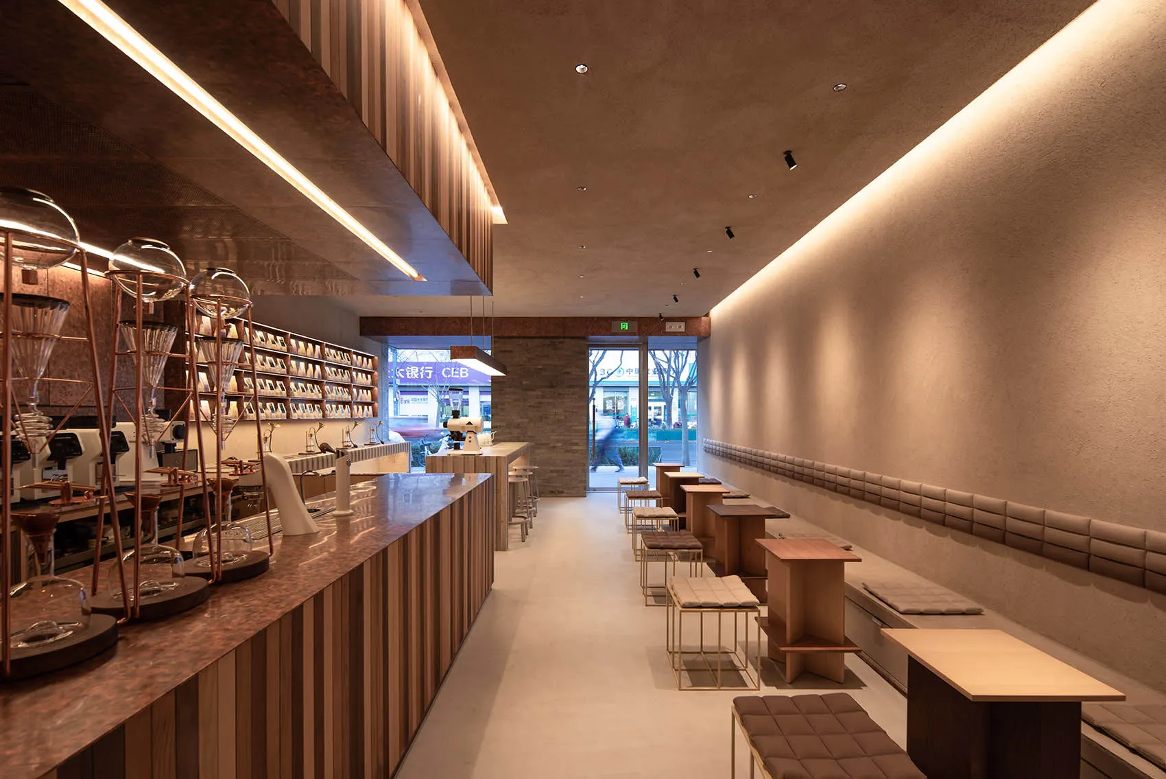 A modern coffee shop with wooden interior design, featuring minimalist decor and sleek, contemporary furniture.