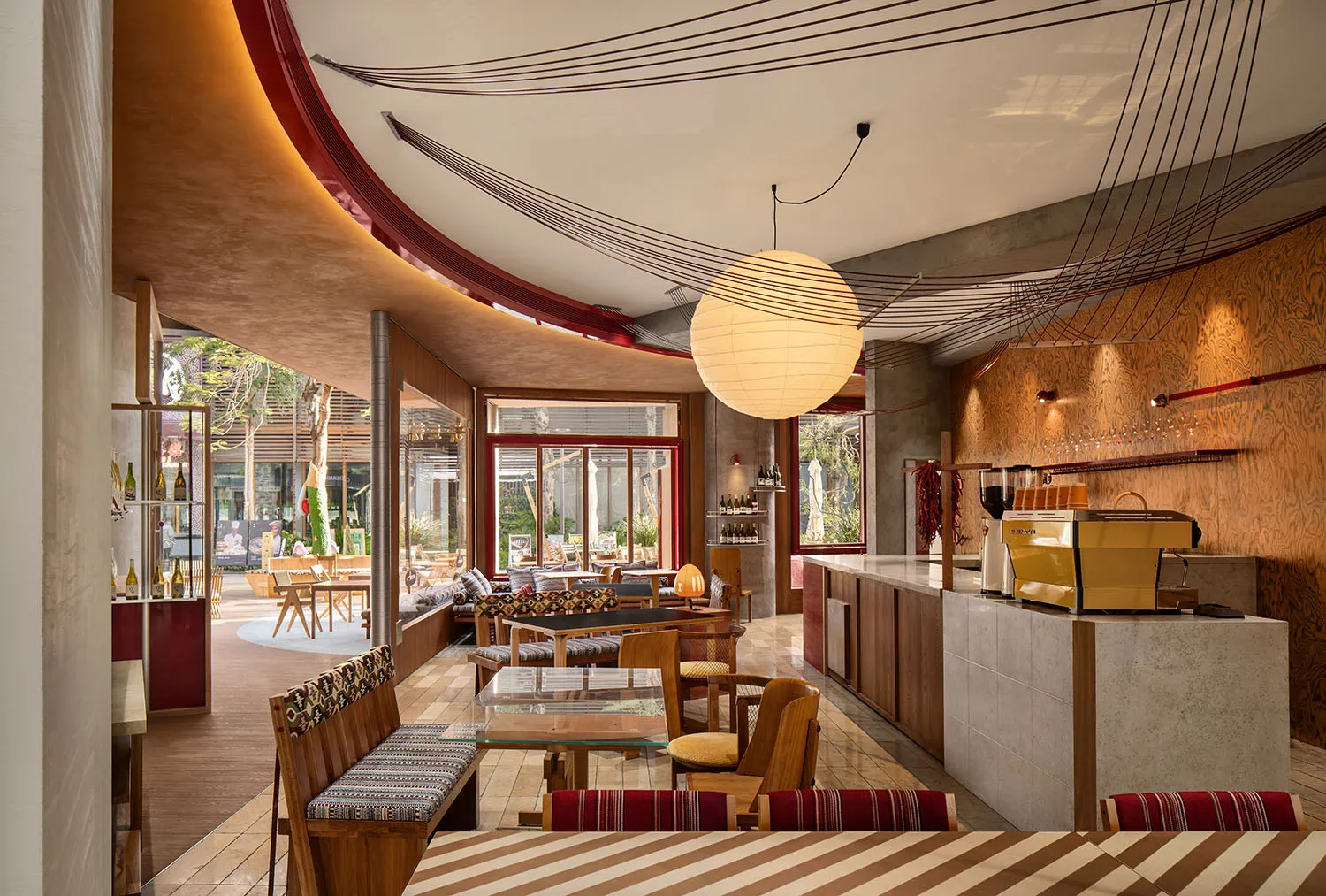 Contemporary cafe interior featuring wooden furnishings and a warm, inviting atmosphere.